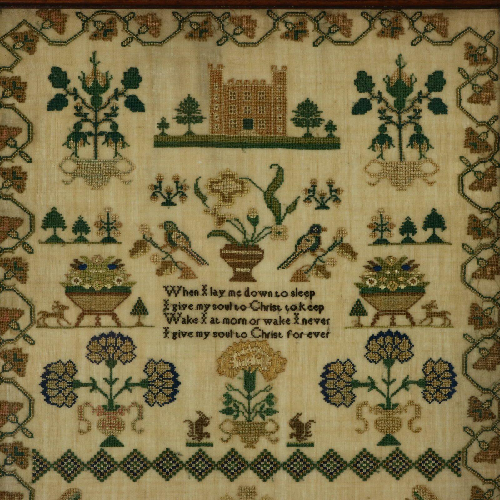 Victorian Sampler, stitched in 1839 by Elizabeth Higgins Aged 14. The sampler is worked in silk threads on a linen ground, mainly in cross stitch. Meandering floral border. Colours green, light brown, dark brown, gold, pink, silver and blue. Verse