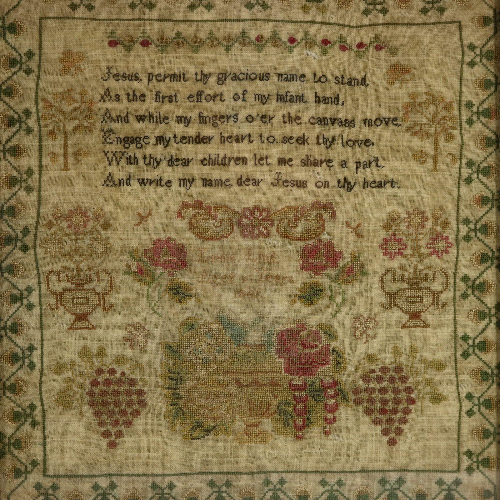 Victorian Sampler, 1840, by Emma Lind. The sampler is worked in silk threads on a linen ground, in cross stitch. Meandering strawberry border. Colours red, green, light brown, gold, black, pink and silver.  Verse reads, 'Jesus, permit thy gracious