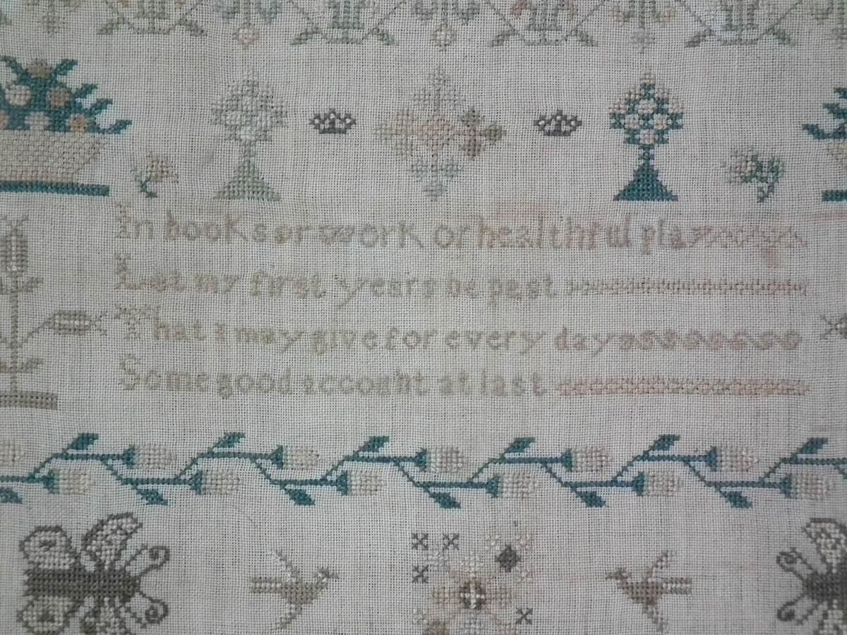 Antique sampler, 1845, by Hannah Sims. The sampler is worked in silk on linen ground, in cross stitch throughout. Meandering strawberry border. Colours brown, green, copper, cream and white. Alphabets A-Z in upper case and lower case. Verse is Isaac