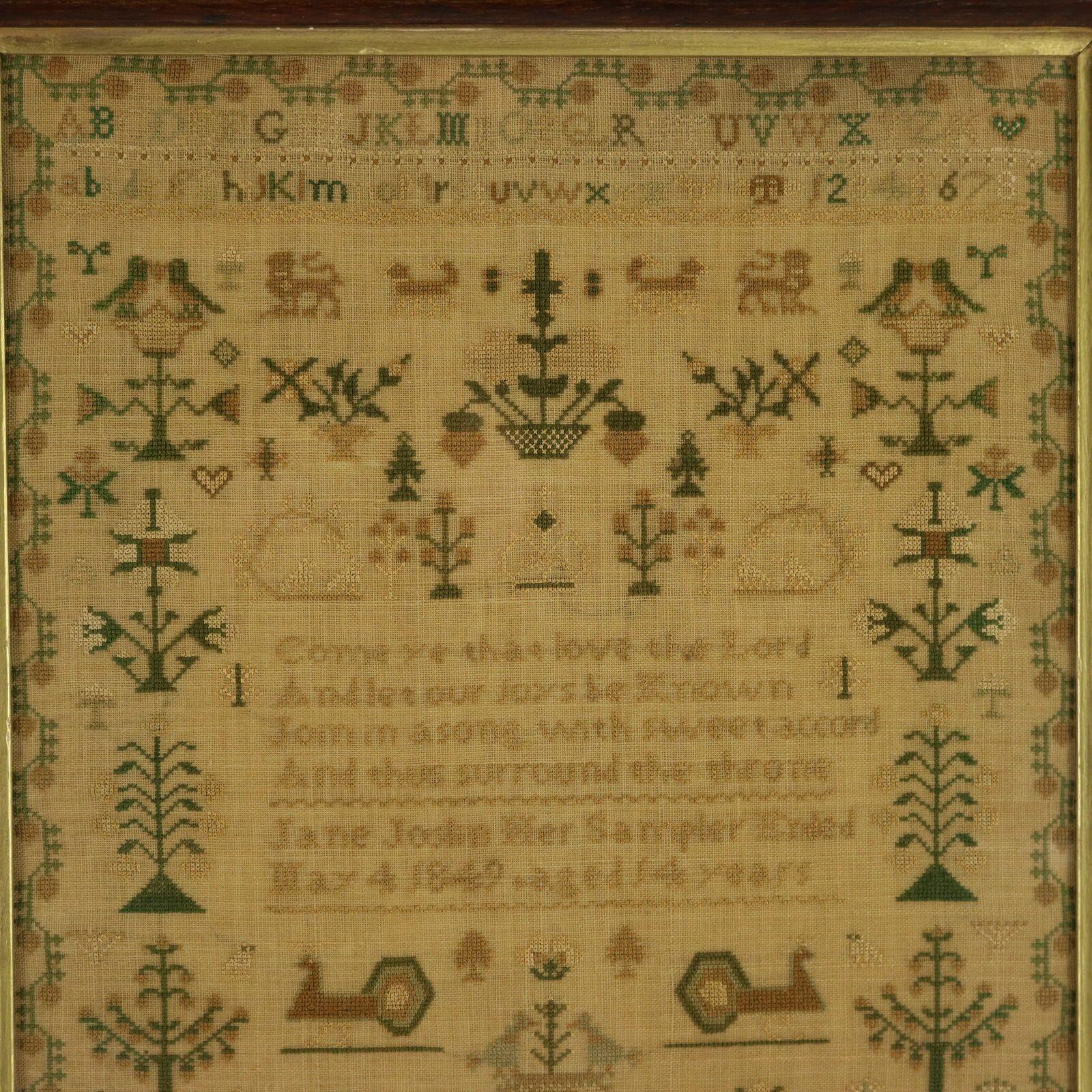 Victorian Sampler, 1849, by Jane Joslin. The sampler is worked in silk on a linen ground, mainly in cross stitch. Meandering strawberry border. Colours gold, pale blue, light brown, copper, green and silver. Alphabets A-Z in upper case and lower