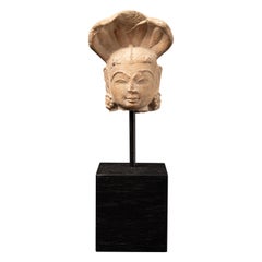Antique sandstone head of a Nagini statue from India