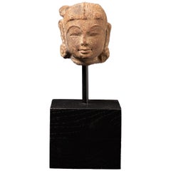 Antique sandstone head of an Apsara statue from India