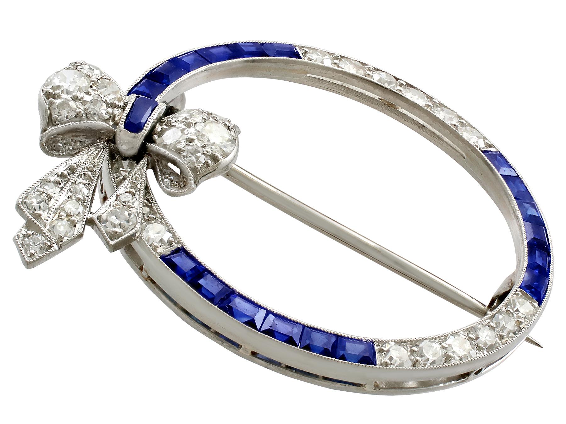 An impressive antique 0.60 carat sapphire and 1.27 carat diamond, platinum bow brooch with an 18 karat white gold pin; part of our diverse antique jewellery and estate jewelry collections.

This stunning, fine and impressive antique sapphire brooch