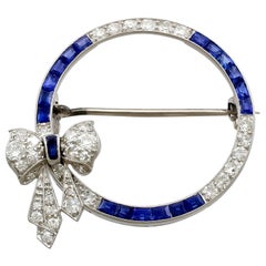Antique Sapphire and 1.27 Carat Diamond Platinum Bow Brooch, circa 1910 Antique Sapphire and 1.27 Carat Diamond Platinum Bow Brooch, circa 1910