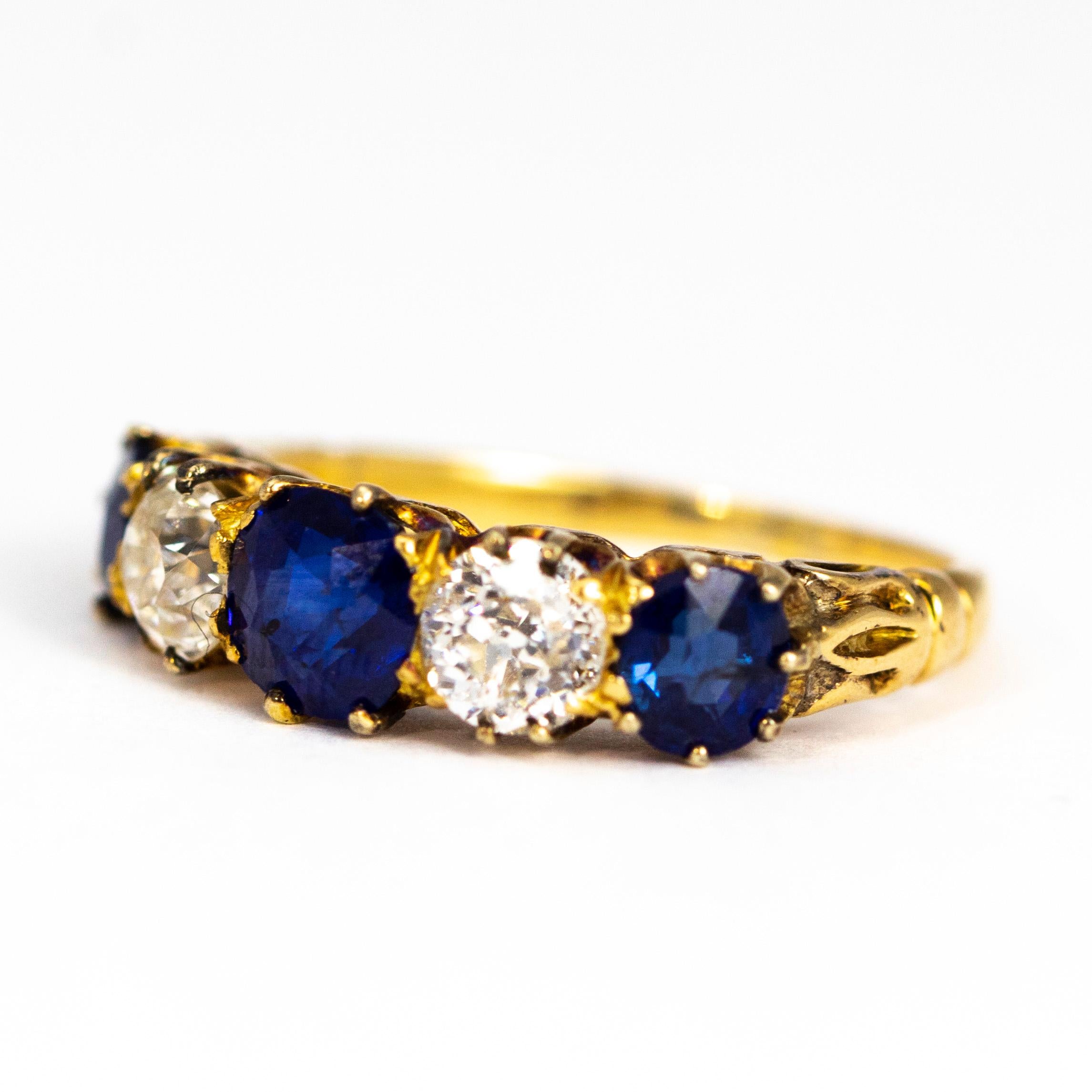 The sapphires in this ring are a deep and gorgeous blue colour. The central stone measures 60pts and the outer measure approximately 40pts each. The old mine cut diamonds which sit in between are a G/H colour VSI. The stones are all modelled in 18ct