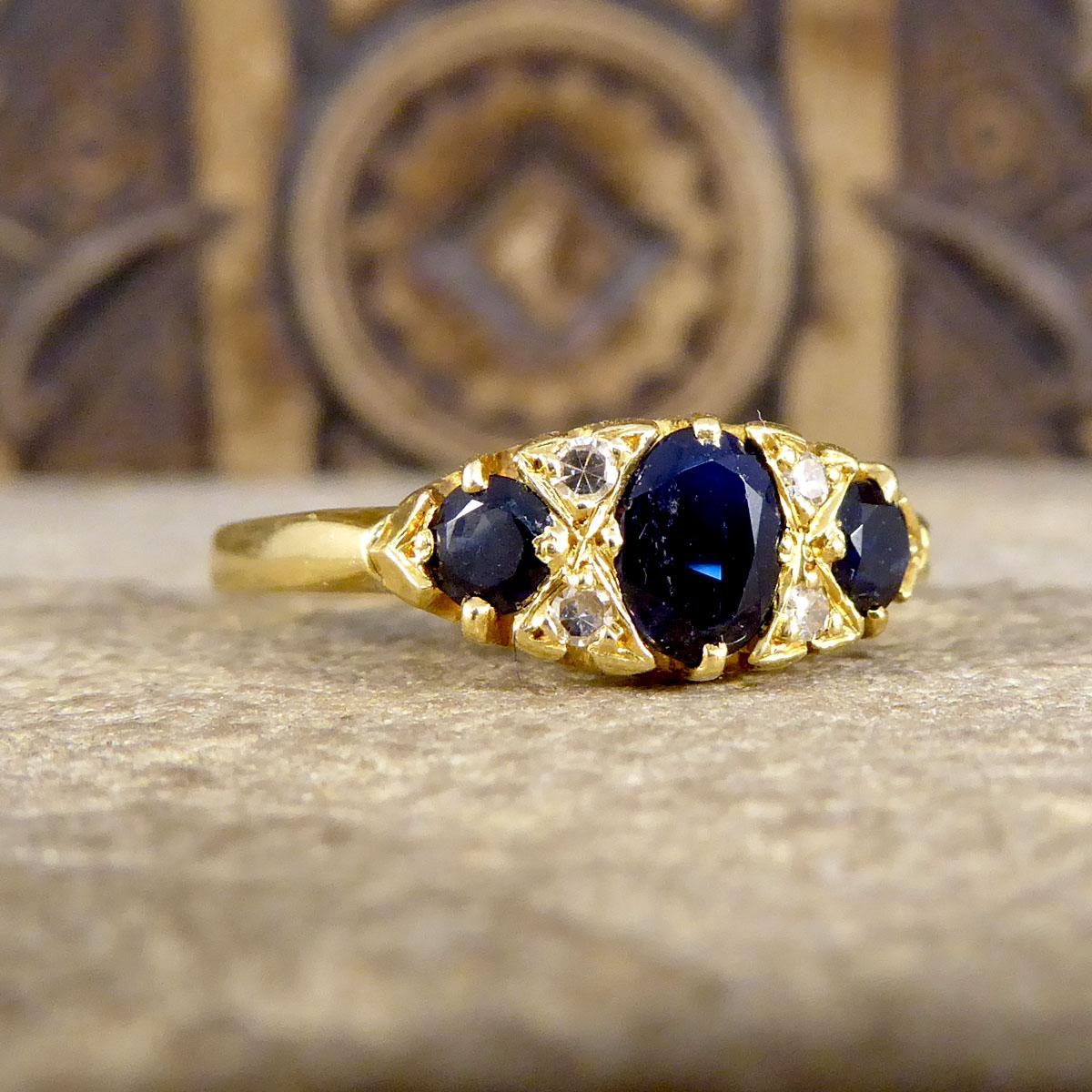 This striking Late Victorian to Early Edwardian ring features an east-west oriented navette-shaped face set with gorgeous deep blue Sapphires and small Rose Cut Diamonds. This boat ring has been crafted from 18ct Yellow Gold with an 18ct stamp on