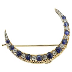 Broche ancienne en forme de croissant en saphir et diamant