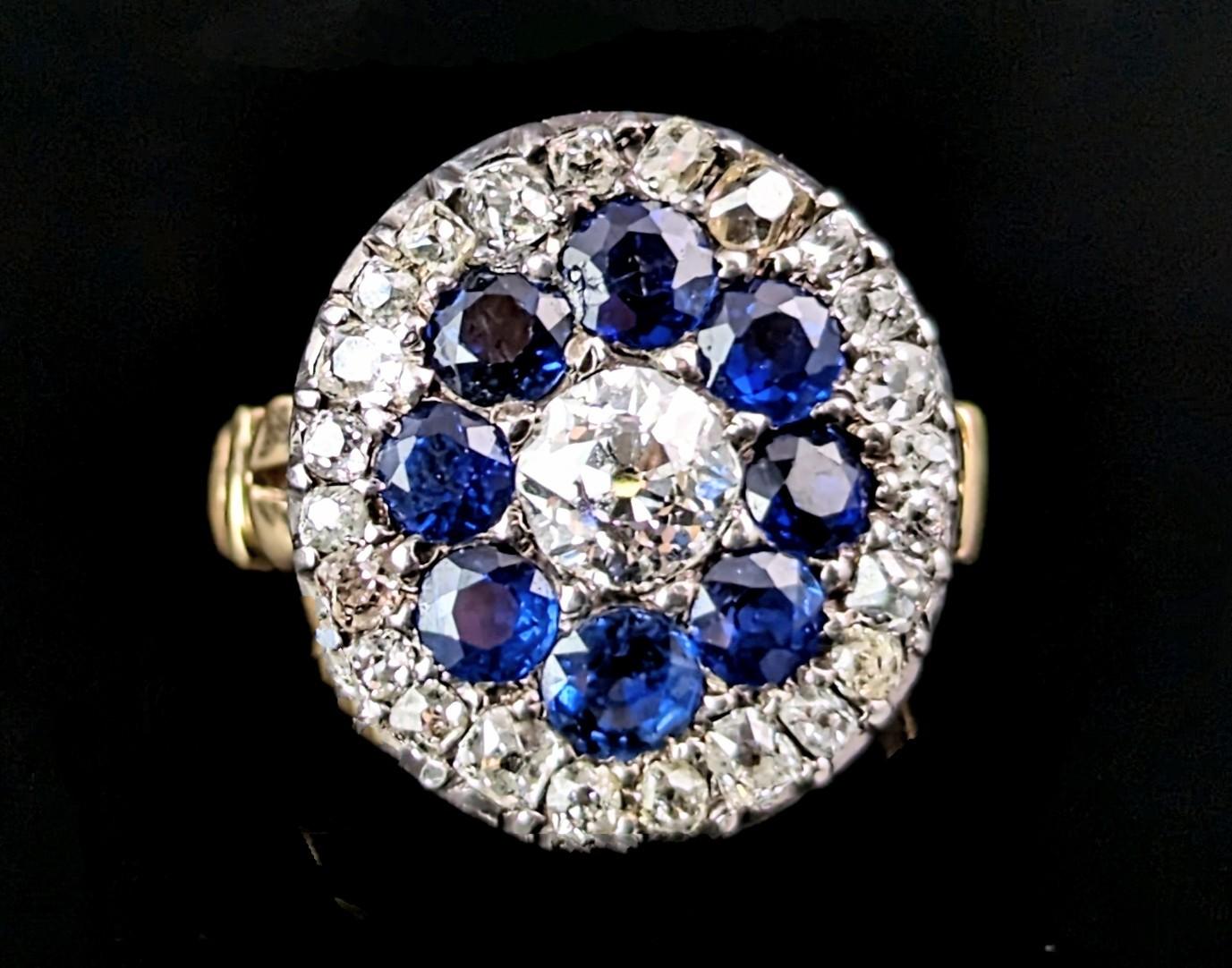 This antique Sapphire and Diamond halo cluster or target ring is truly a majestic beauty!

A ring fit for royalty this piece has so much sparkle and shimmer with old cut and cushion cut diamonds and those beautiful deep royal blue sapphires, there