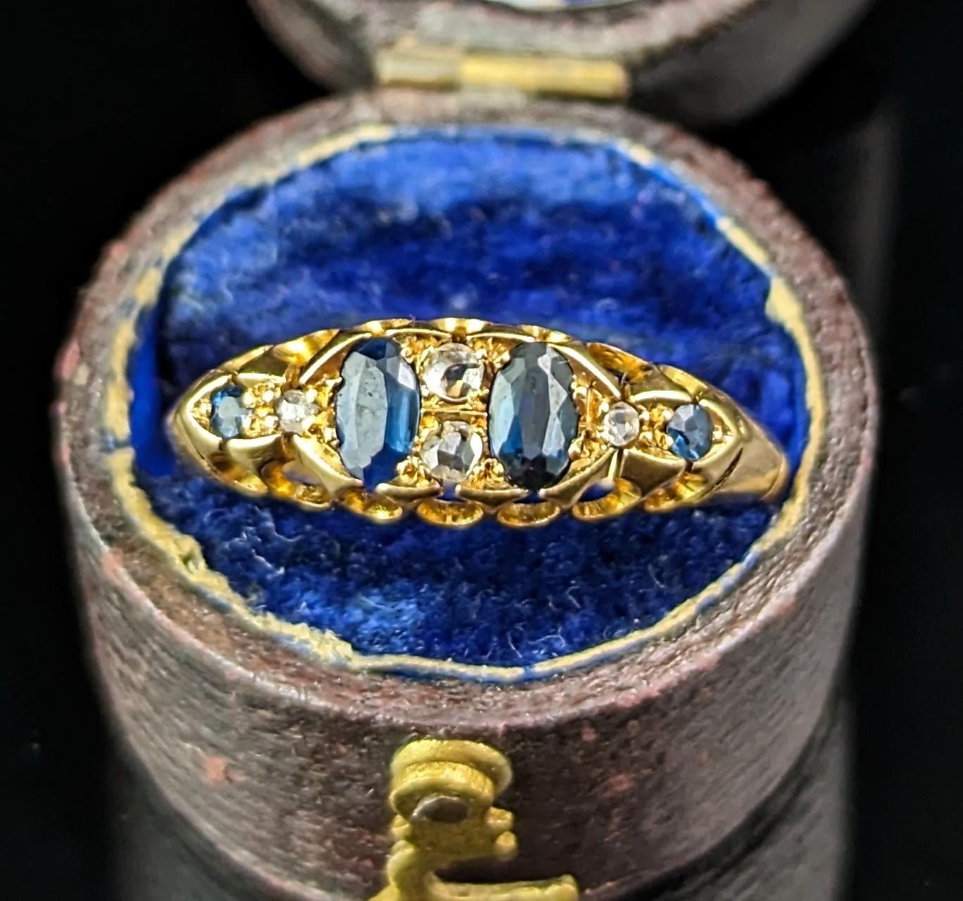 You can't help but fall in love with this beautiful antique Sapphire and Diamond ring.

Set in rich buttery 18ct gold, this design is also known as a boat head style, it has a scrolling design to the top and bottom of the gallery with lightly ridged