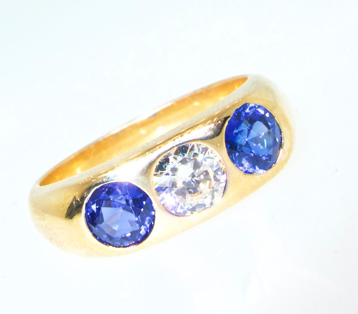 Antique diamond and sapphire ring, the two natural blue unheated sapphires display a bright, vivid blue - an almost perfect, sought after, sapphire blue color.  The weight of these fine sapphires is estimated to be .93 cts.  The white diamond is