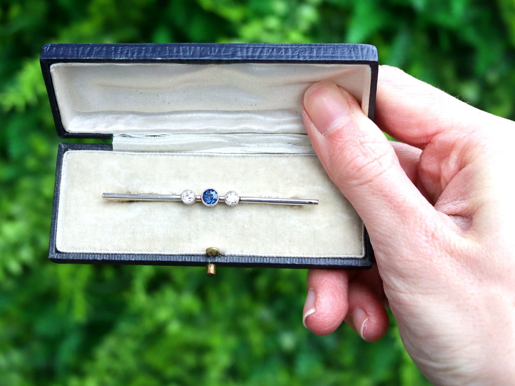 A fine and impressive antique 0.28 carat natural blue sapphire and 0.35 carat diamond, 12k yellow gold, platinum set bar brooch; part of our antique jewelry and estate jewelry collections.

This fine and impressive sapphire and diamond brooch has