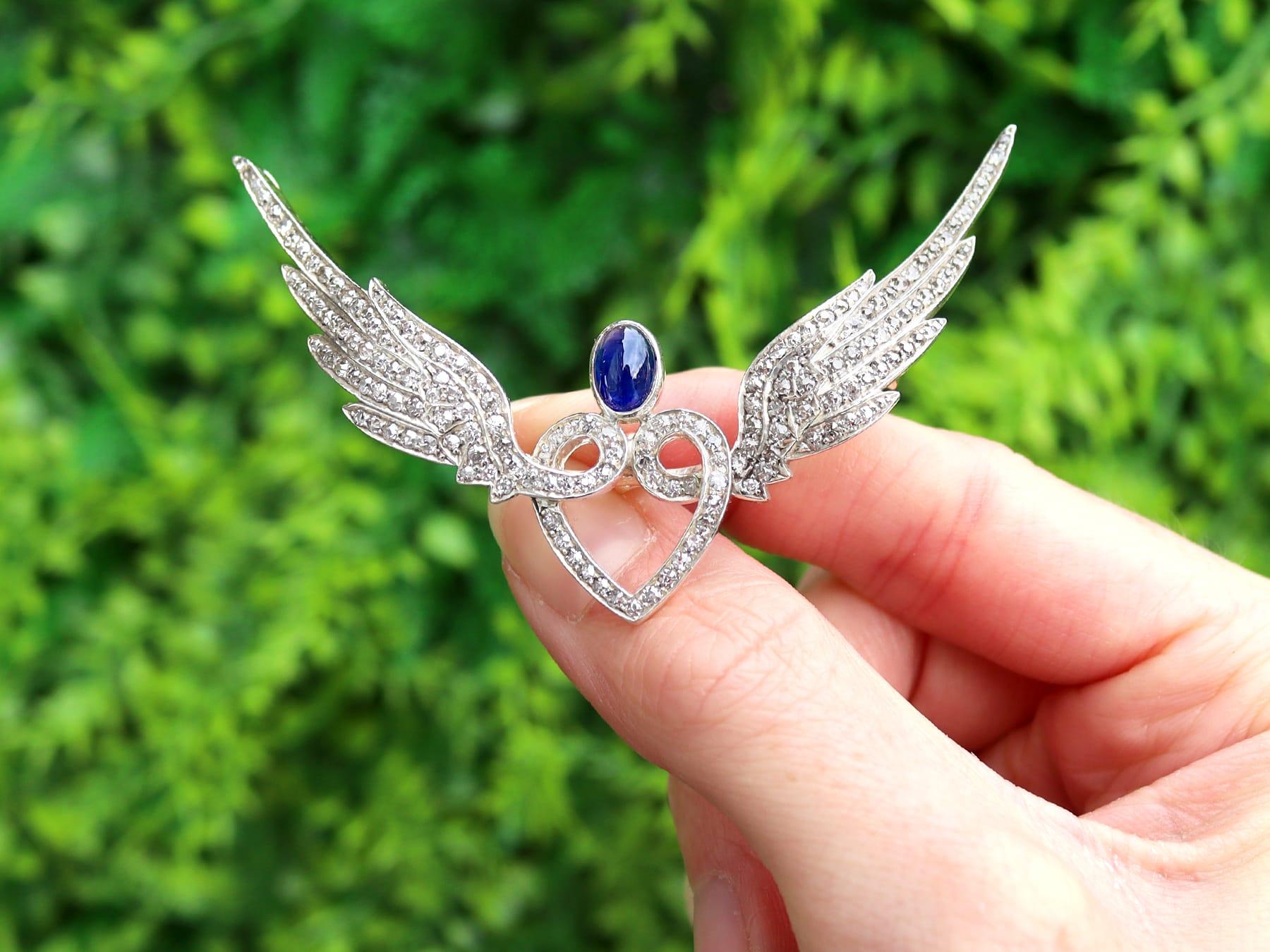 A stunning, fine and impressive, large 1.55 carat sapphire and 2.20 carat diamond, 10 carat yellow gold and silver set sweetheart brooch/pendant with wings; part of our diverse antique jewellery collections.

This stunning, fine and impressive