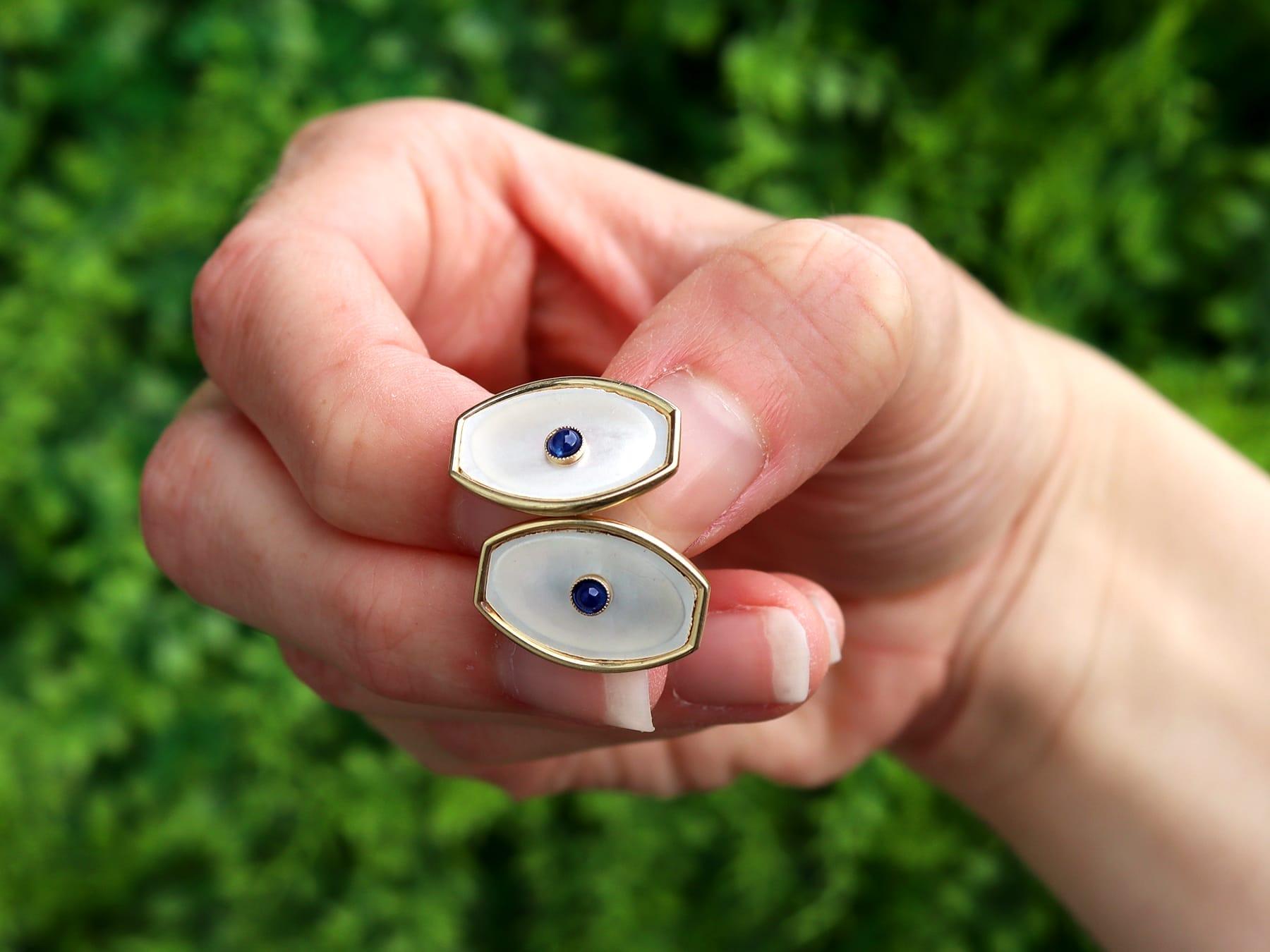 An impressive pair of antique mother of pearl and 0.12 carat sapphire, 14 karat yellow gold cufflinks; part of our diverse antique jewelry and estate jewelry collections.

These fine and impressive antique cufflinks have been crafted in 14k yellow
