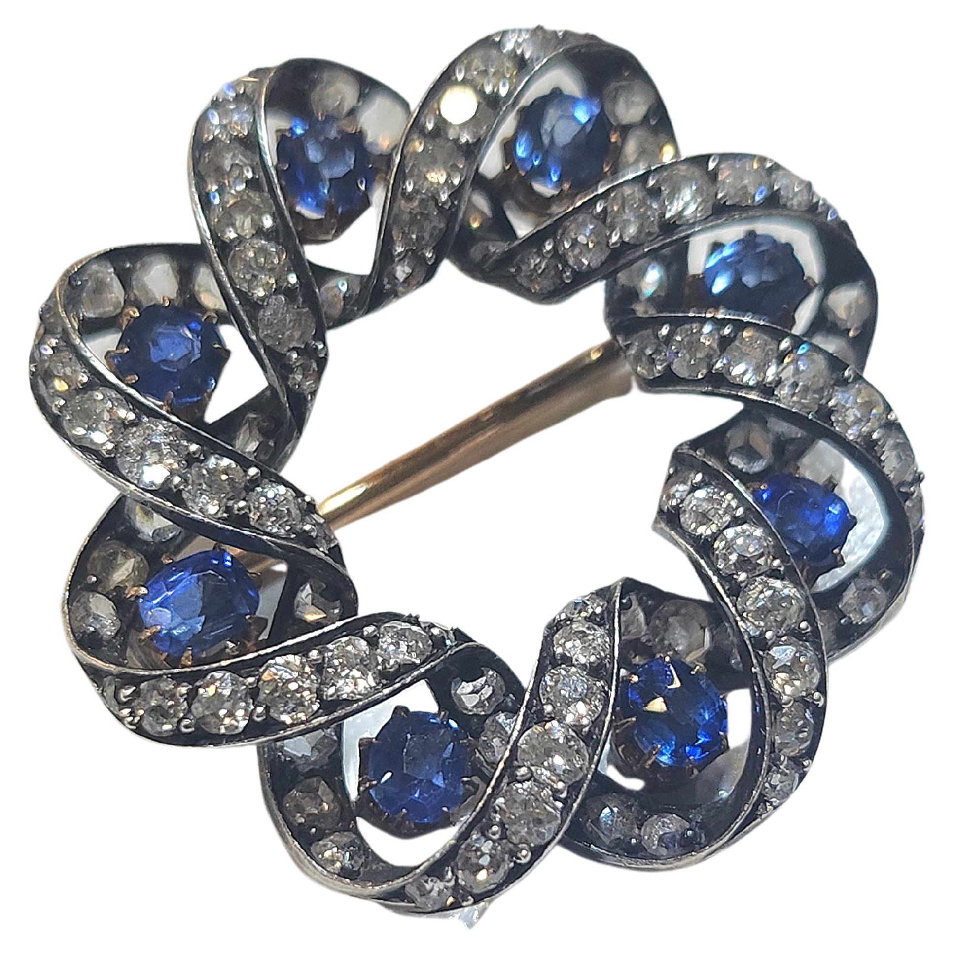 Antique brooch in circular designe gold topped with silver decorted with natural ceylon blue sapphire estimate weight of 1 carat and rose cut diamonds estimate weight 2 carats brooch diameter 3cm dates back to europe 1880/1899.c
