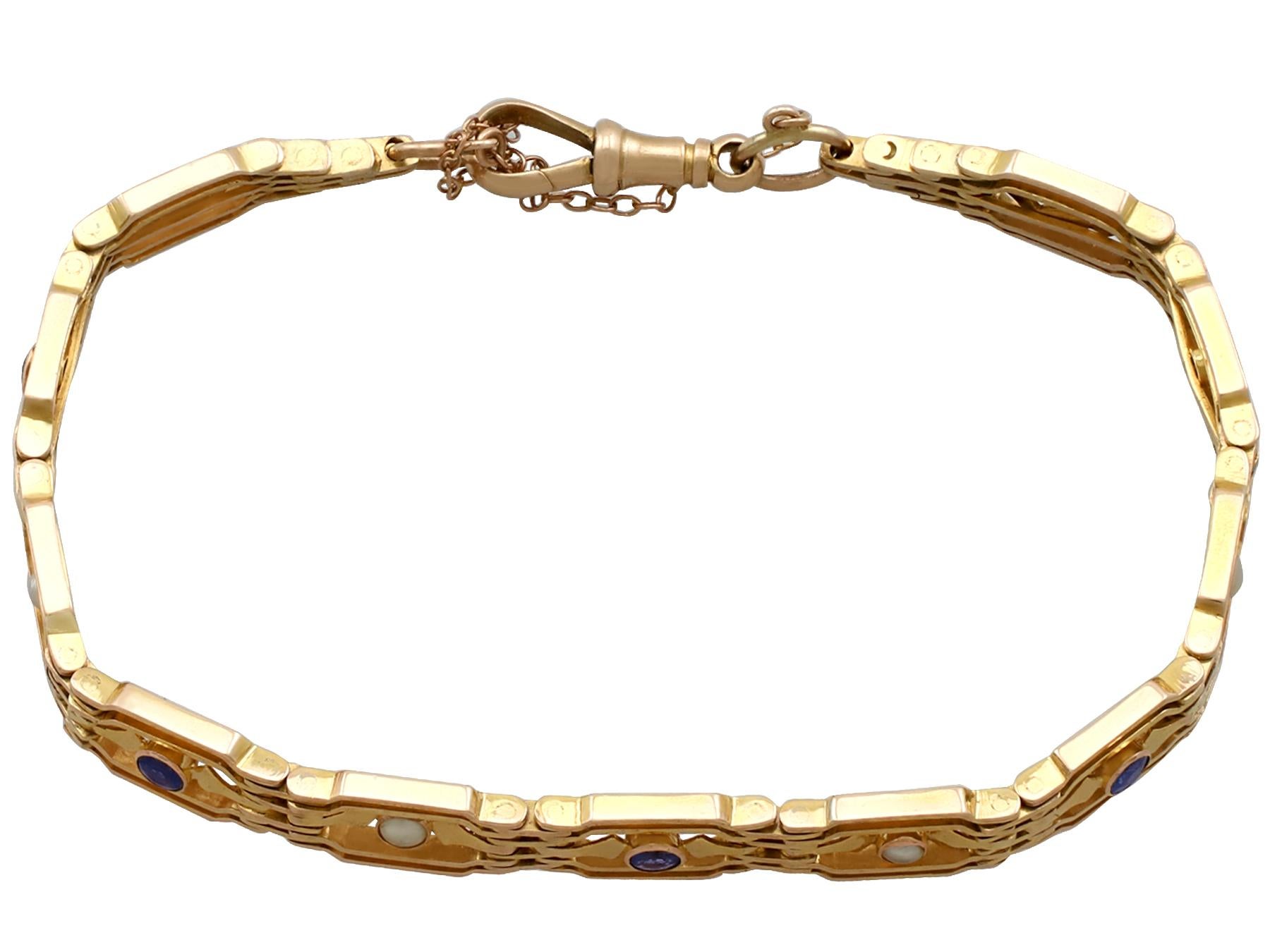 An impressive antique 0.65 carat sapphire and seed pearl, 9 karat yellow gold gate style bracelet; part of our diverse antique jewelry collections.

This fine and impressive sapphire and pearl bracelet has been crafted in 9k yellow gold.

The eleven