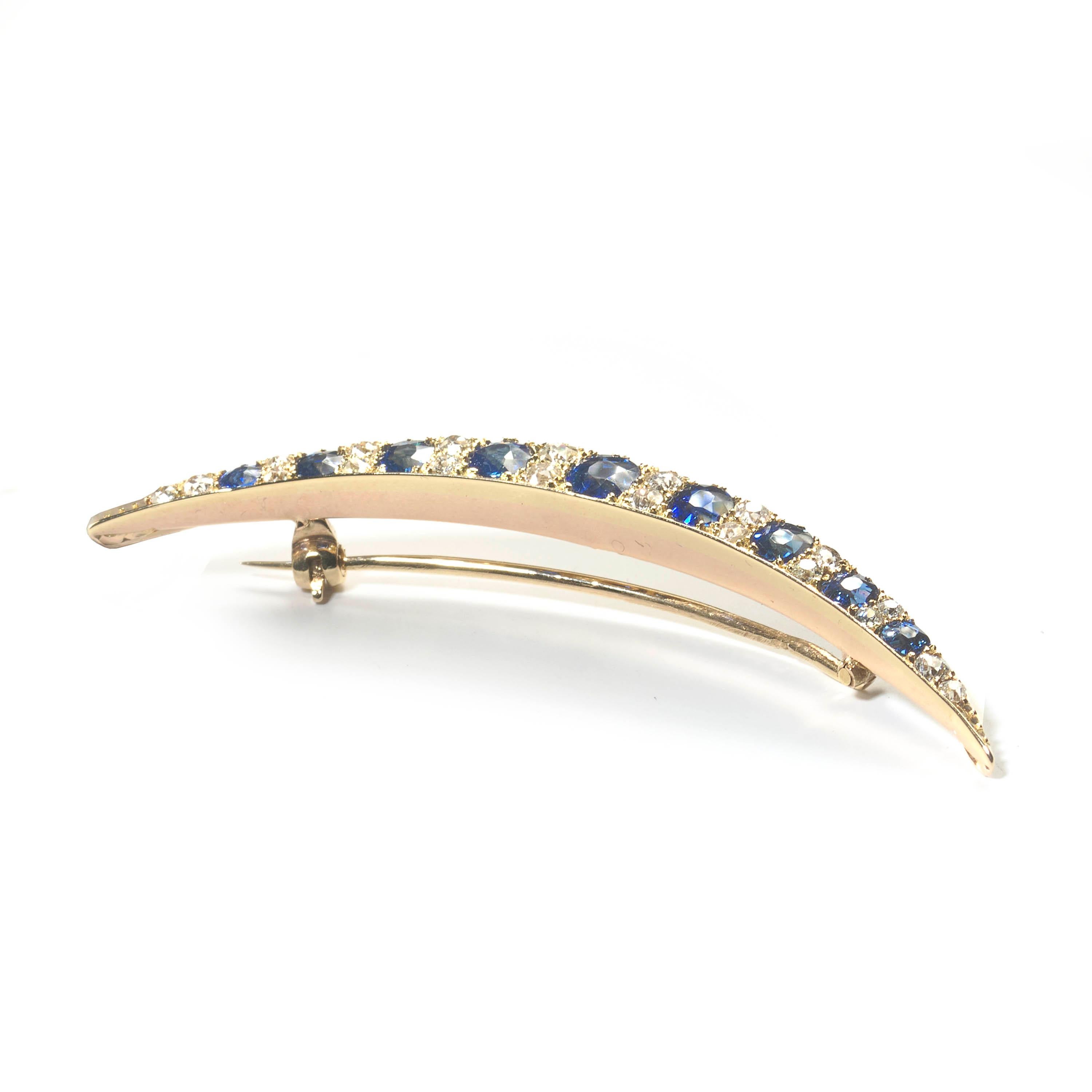 An antique sapphire and diamond crescent brooch, set with nine, oval and round faceted sapphires, graduating in size, with an estimated stone weight of 1.75ct, alternating with eight pairs of old-cut diamonds, terminating with two old-cut diamonds