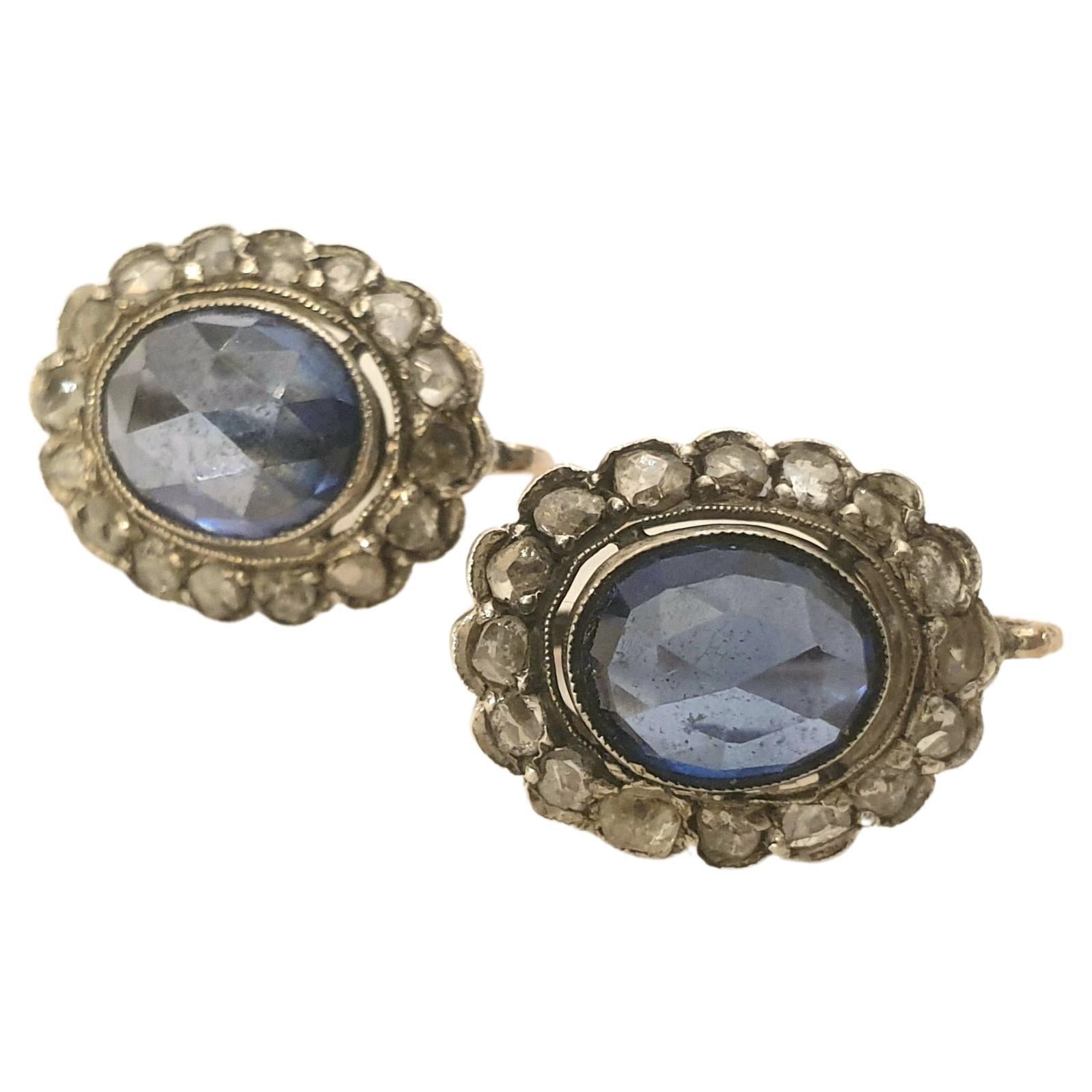Antique earrings centered with navy blue colour sapphire in rose cut facets with a diameter of 9mm×8.5mm each flanked with several rose cut diamonds in earrings setting mix of 10k gold and silver total earrings length 1.5cm dates back to 1880/1890.c
