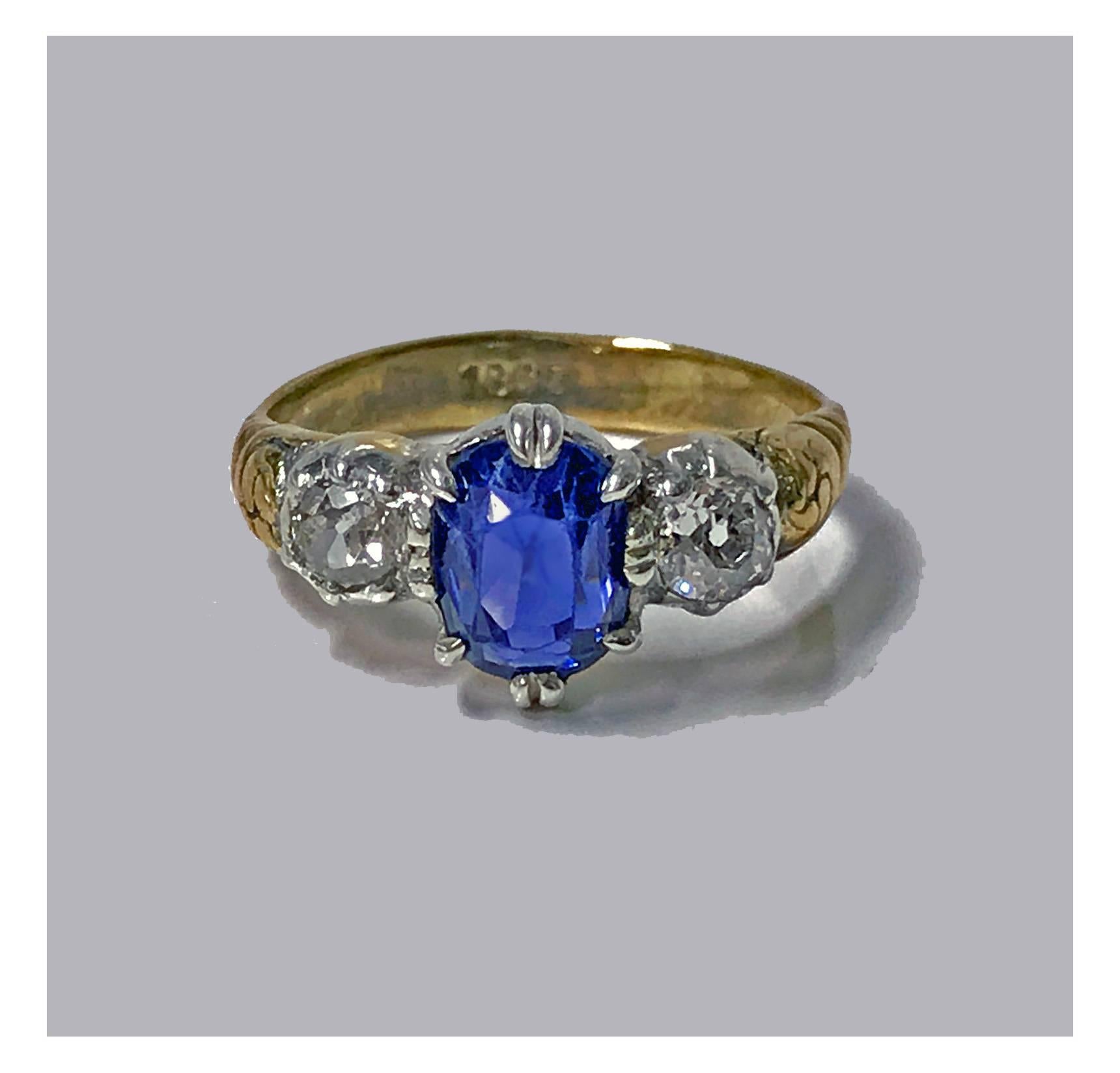 Antique 19th century 18K Sapphire and Diamond Ring, English C.1850. Oval Ceylon Sapphire approximately 2.30 ct, two old mine cut diamonds, Total Diamond Weight: approximately 0.50 ct, average VS2-SI1 clarity, average I-J colour. Total Item Weight: