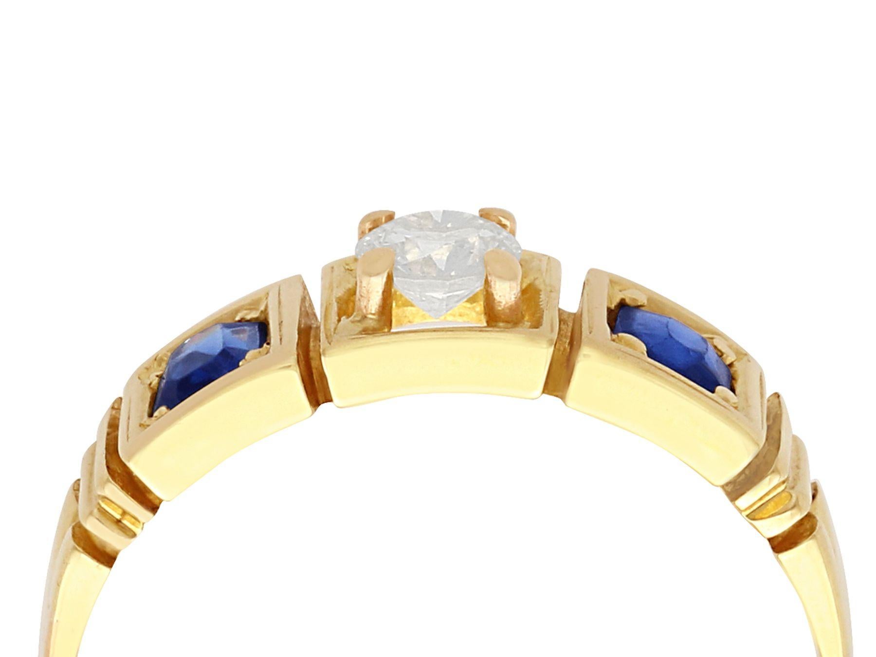 A fine and impressive antique Victorian 0.62 carat natural blue sapphire and 0.29 carat diamond, 15 karat yellow gold three stone dress ring; part of our antique jewelry / estate jewelry collections.

This impressive antique dress ring has been