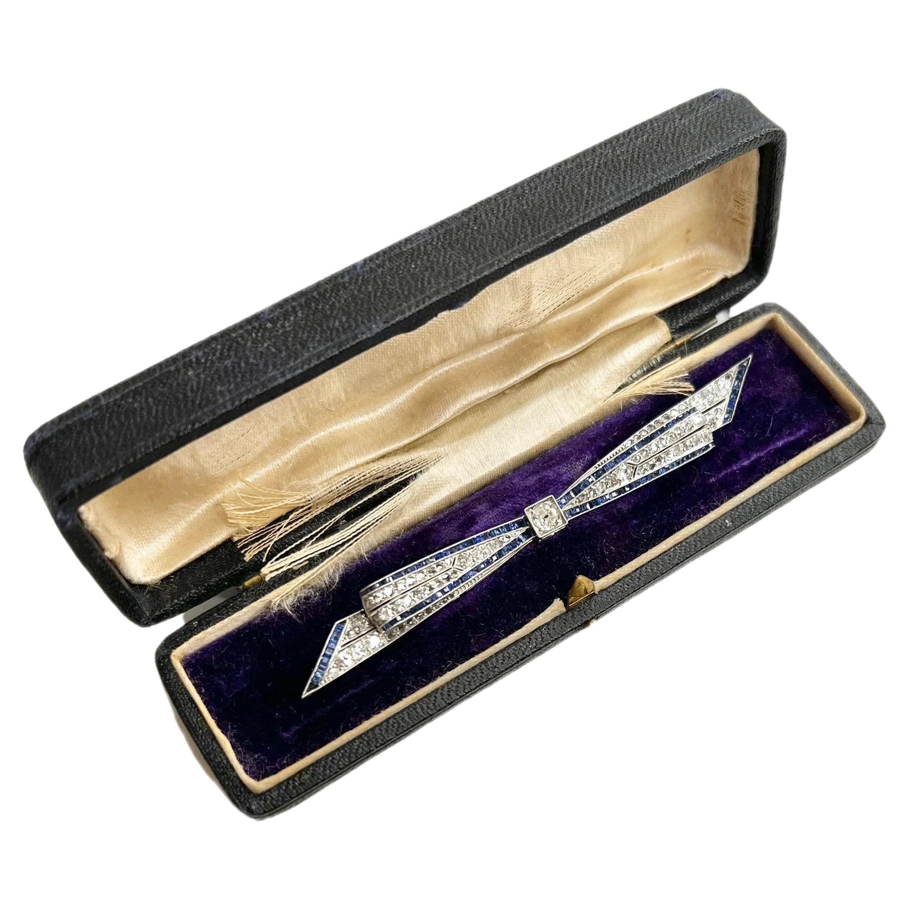 Antique Sapphire & Diamond Platinum Bow Brooch For Sale