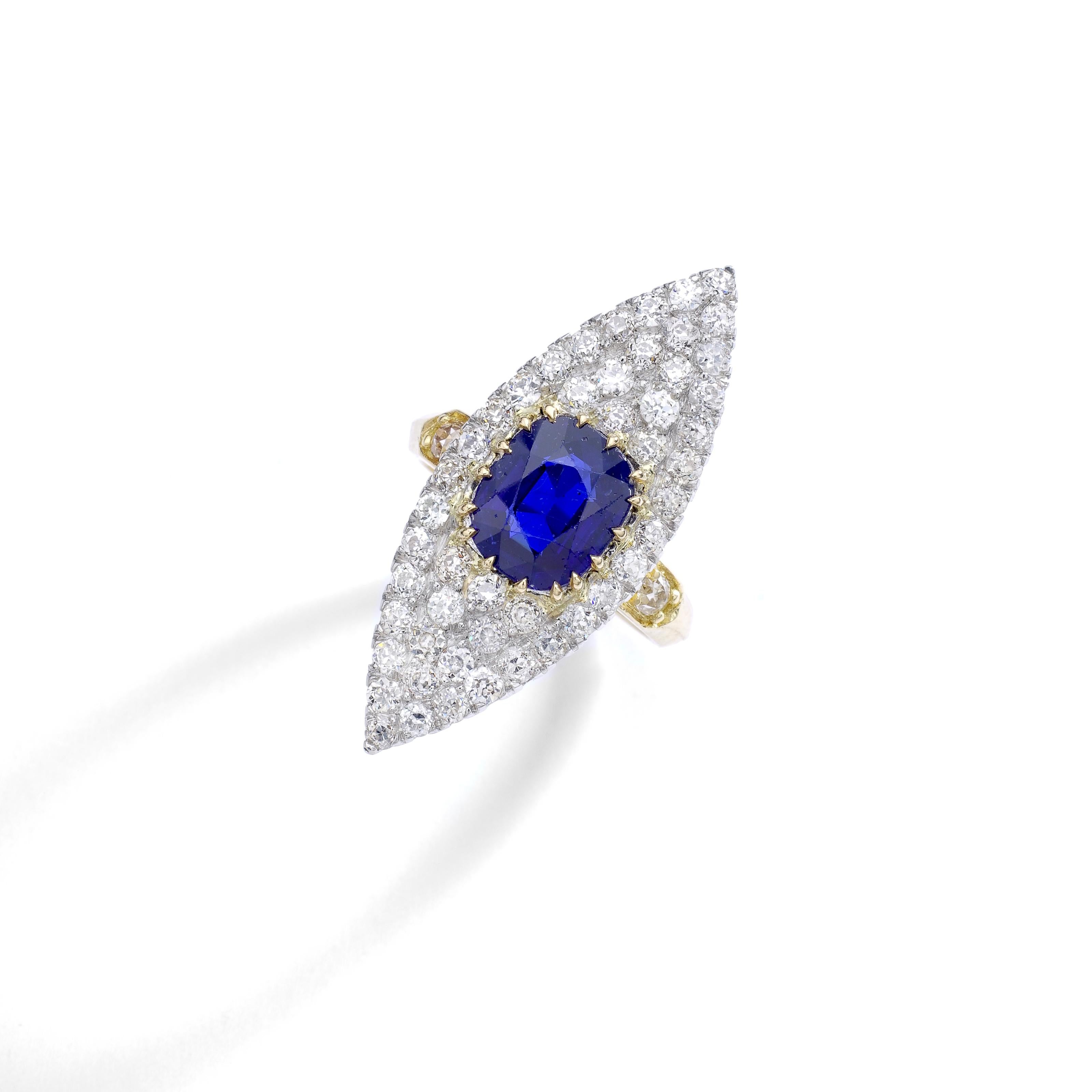 An Antique Marquise ring centered by a cushion Natural Sapphire (approximately 2.88 carat) surrounded by Old mine cut Diamond mounted on platinum and yellow gold.
Circa 1910.
Ring size: 5 1/2 US.