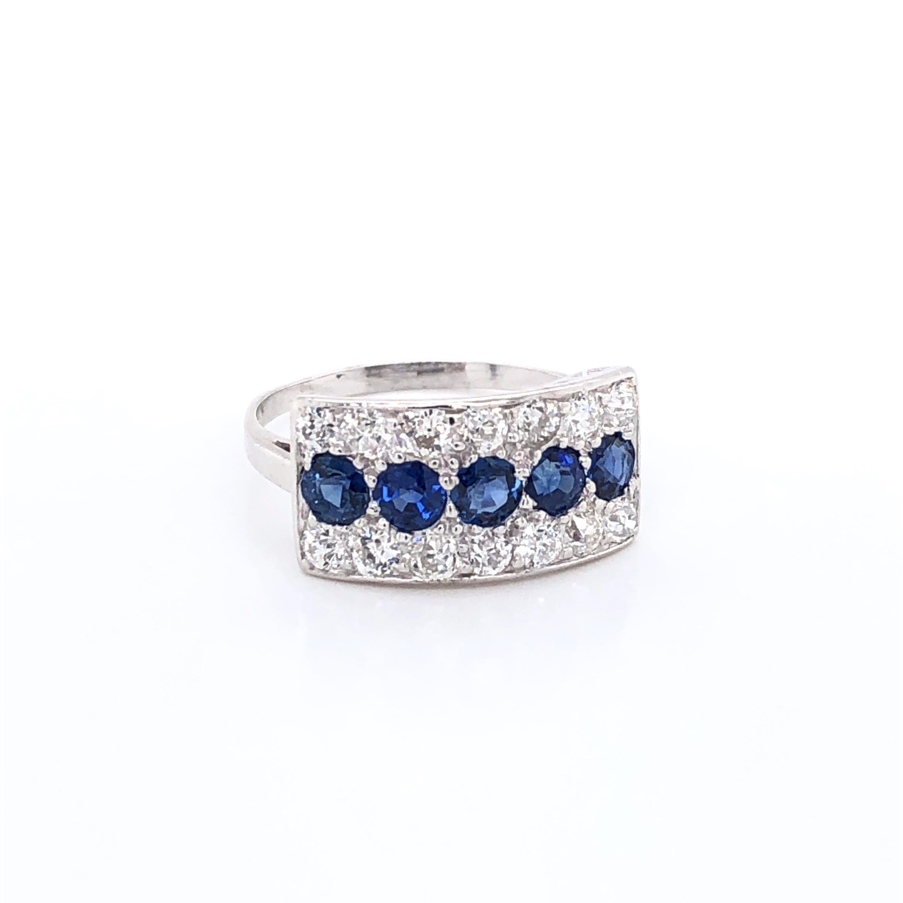 This dazzling antique diamond and sapphire ring will certainly get noticed for its unique rectangular raised platinum setting measuring 5/8