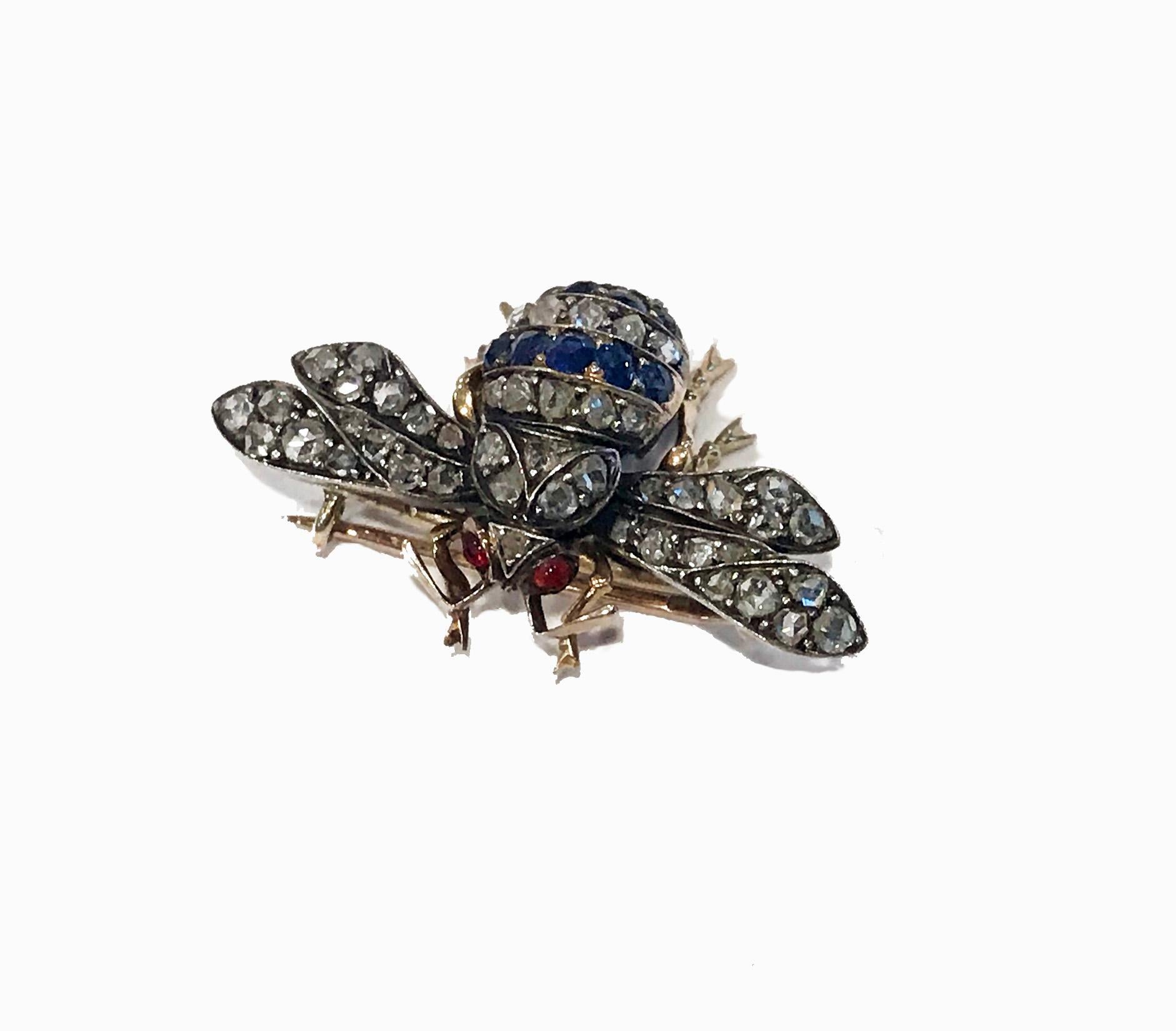 Antique Sapphire Diamond Ruby Bee Brooch, set with 49 old rose cut diamonds, 9 old cut sapphires, with cabochon rubies for the eyes, mounted Gold and cut down silver. English, circa 1880, detachable safety chain. Wing Spread: 1.50 inches. Item