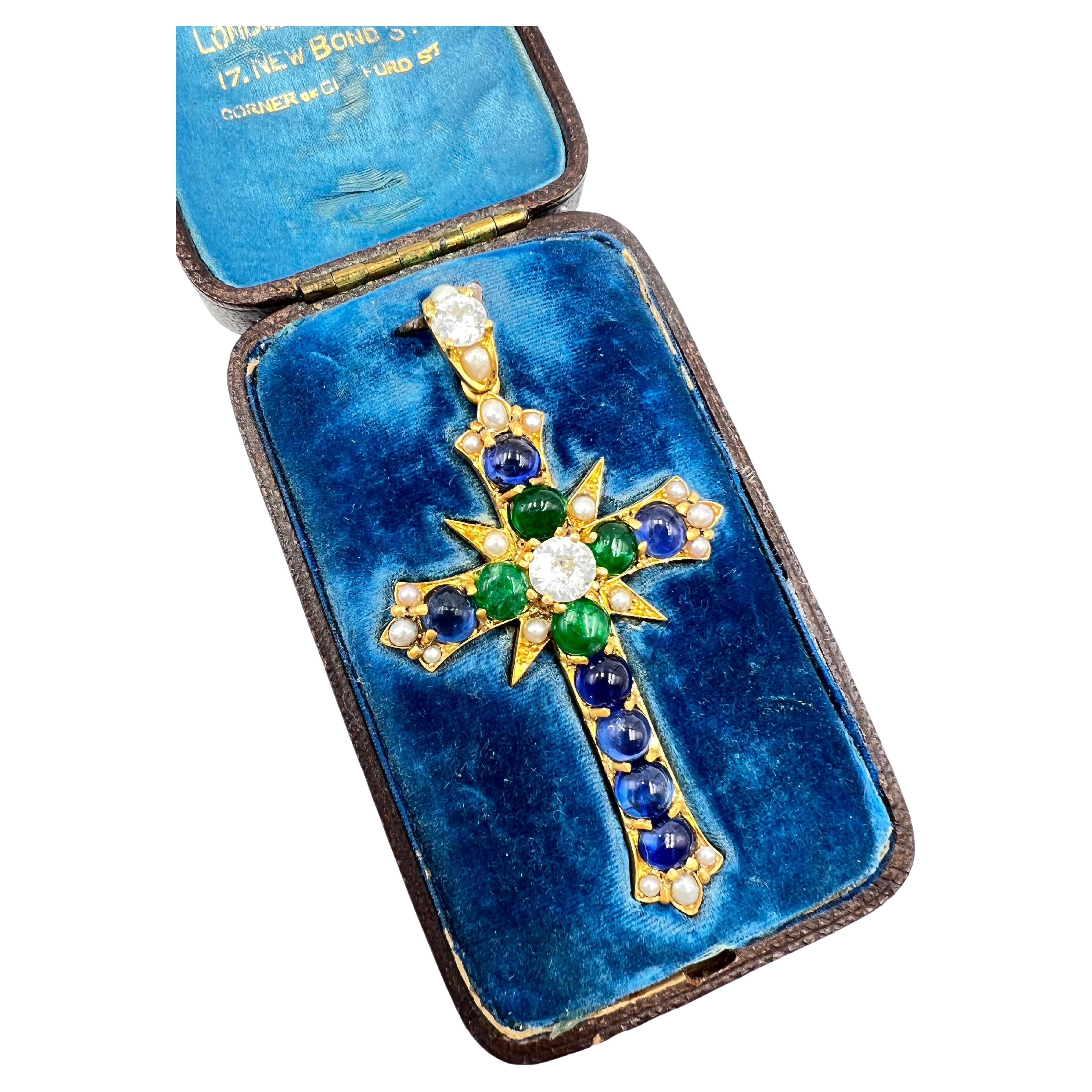 19th Century gold gem set cross pendant, centering an old European cut diamond weighing approximately 1.00 carats accented by four round & oval, cabochon cut, natural emeralds (measuring approximately 5-5.5mm each) and seven round & oval, cabochon
