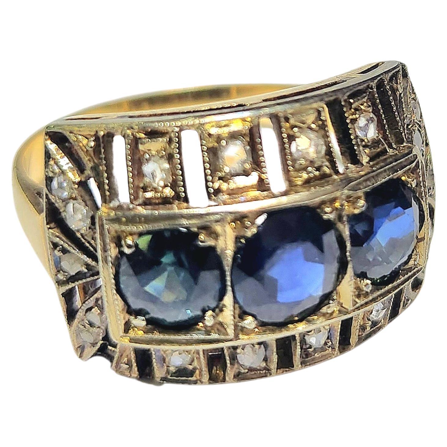 Antique 18k gold ring art deco era centered with 3 natural navy blue sapphires in round cut decorted with diamonds in artdeco open work style ring topped with white gold 