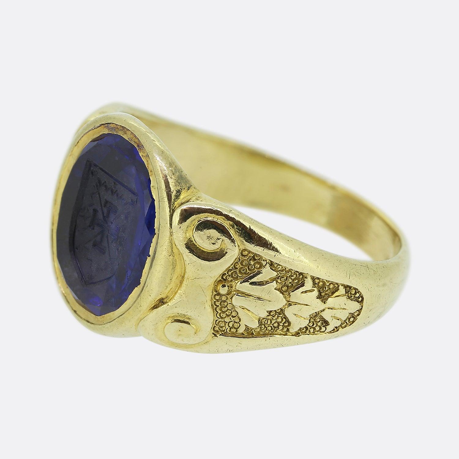 Here we have an outstanding sapphire intaglio signet ring. This antique piece has been crafted from 18ct yellow gold and focally showcases a rich high quality sapphire at the centre of the face with a deep intaglio of a coat of arms or crest. A pair