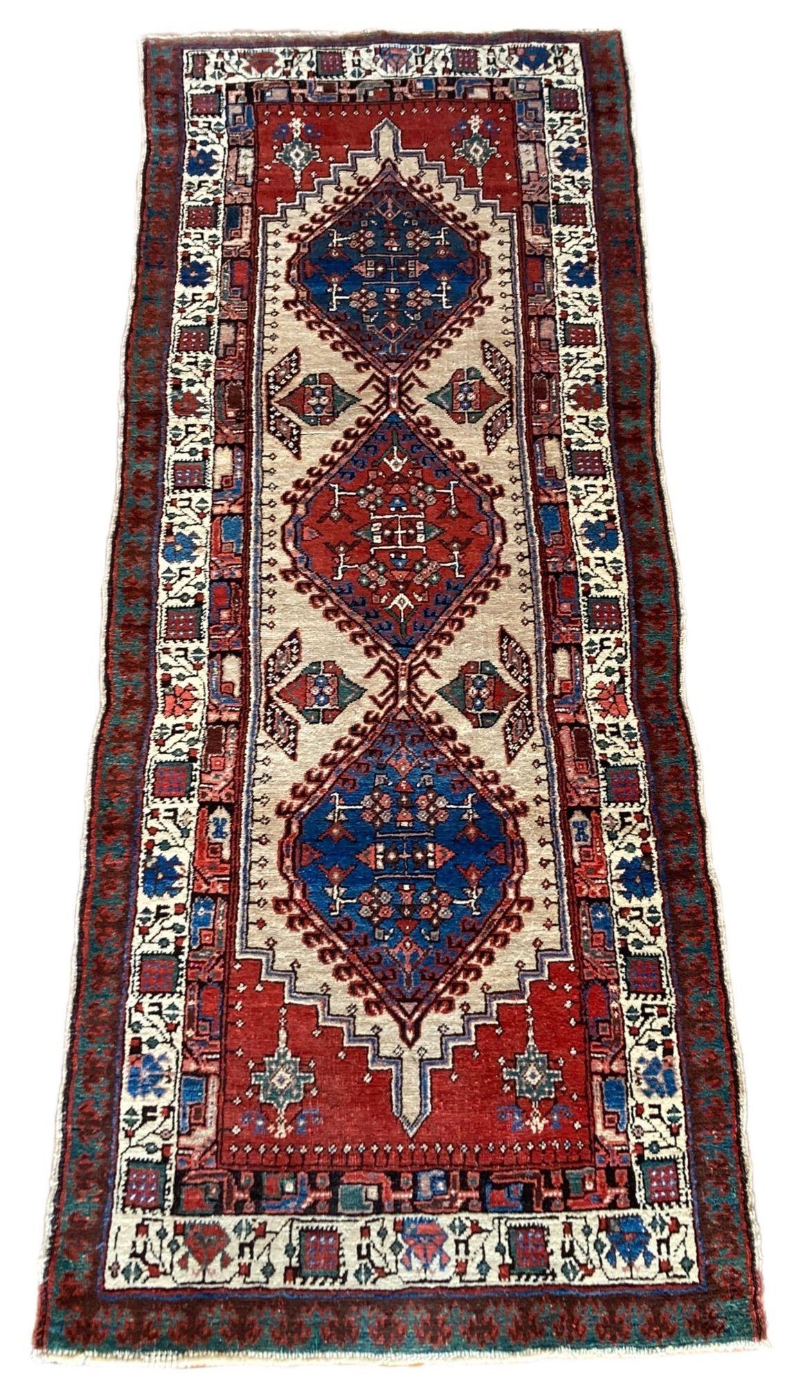 A fabulous little Sarab runner, handwoven circa 1910 with a traditional geometrical design on an ivory field and similar border. Finely woven with lovely quality wool and a decorative little runner.
Size: 2.22m x 0.89m (7ft 4in x 2ft 11in)
This rug