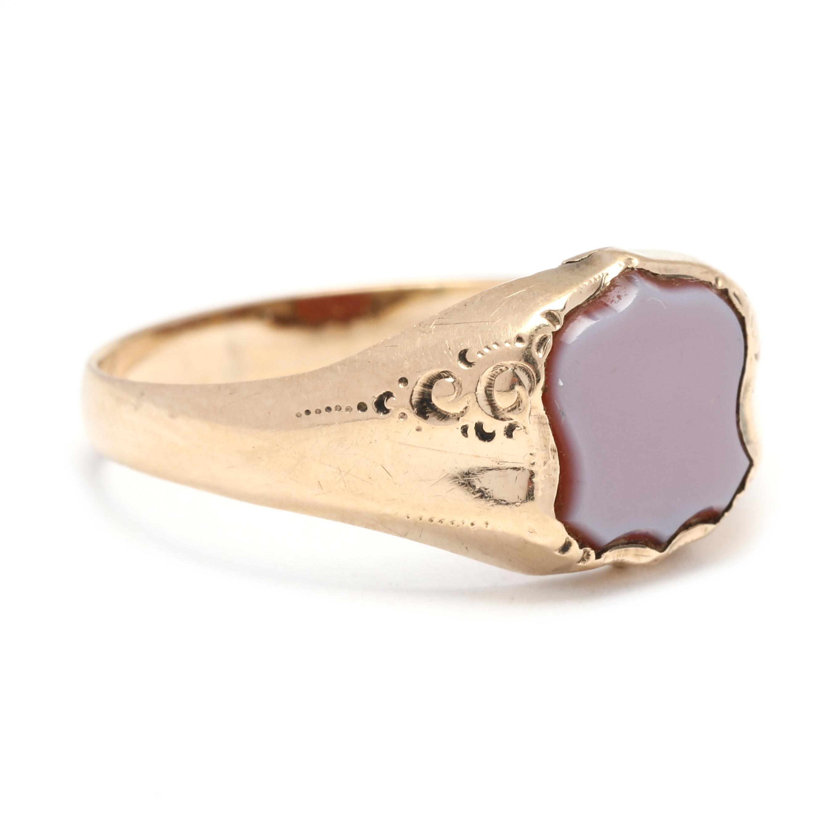 Enhance your style with this antique 14K yellow gold Sard shield signet ring. This unique and rare piece features an engraved shield design on the face of the ring, adding a touch of historical charm. The Sard gemstone, also known as carnelian, has