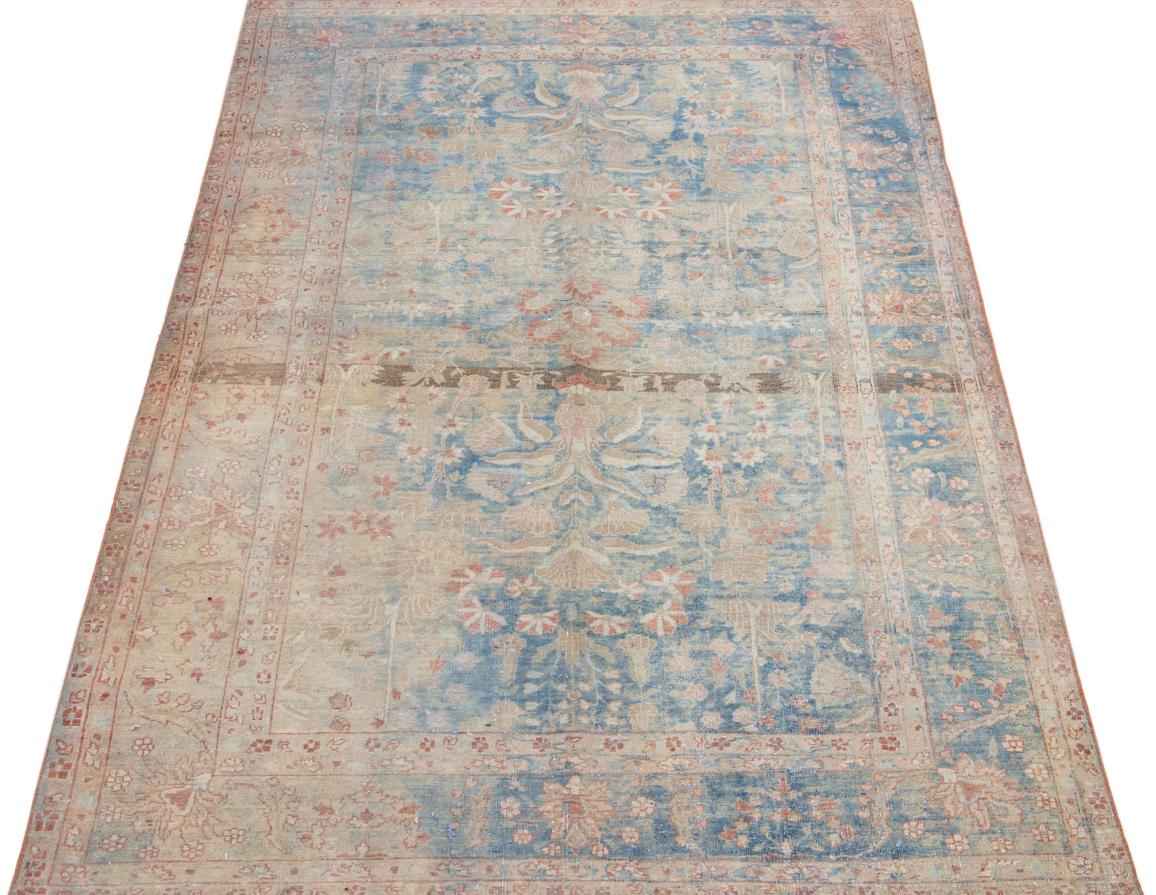 Beautiful Antique Sarouk hand-knotted wool rug with a blue color field. This Persian rug has a Classic floral design in beige, rust, and brown.

This rug measures: 4'1
