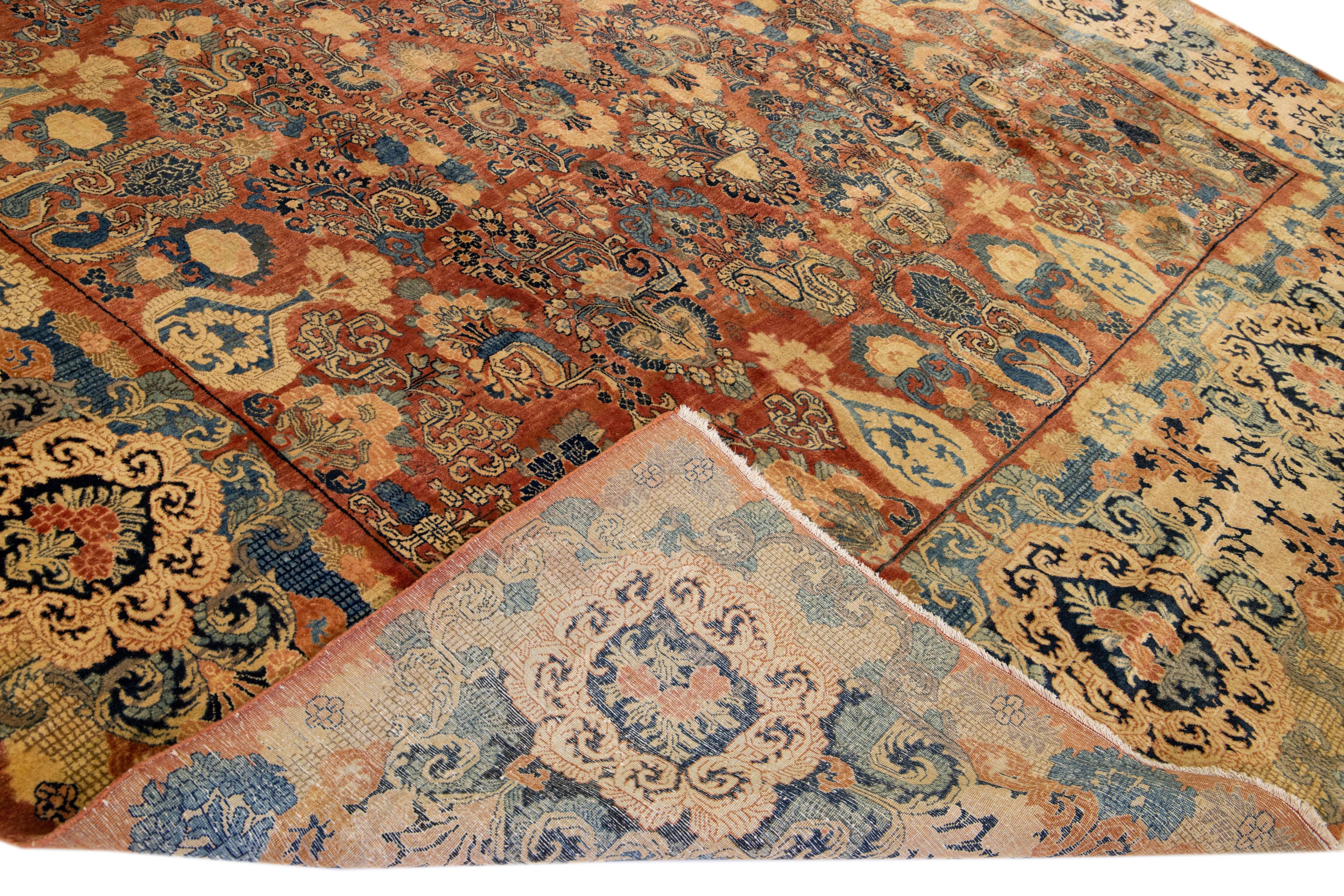 Beautiful Antique Farahan hand-knotted wool rug with an orange field. This Persian rug has a designed frame with multi-color accents on a Classic floral design.

This rug measure: 12' x 19'2
