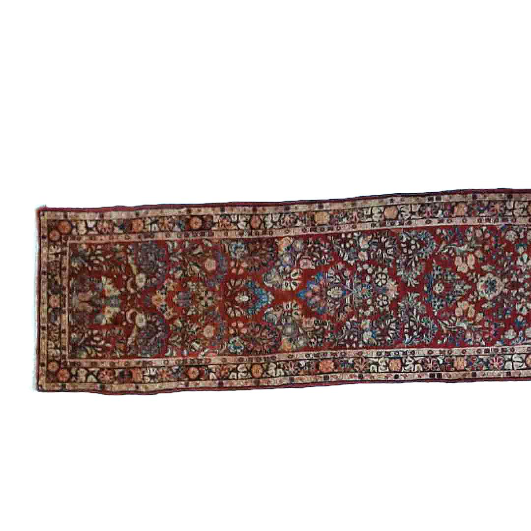 An antique Sarouk oriental rug runner offers wool construction with floral design, 20’ long, circa 1930

Measures - 31
