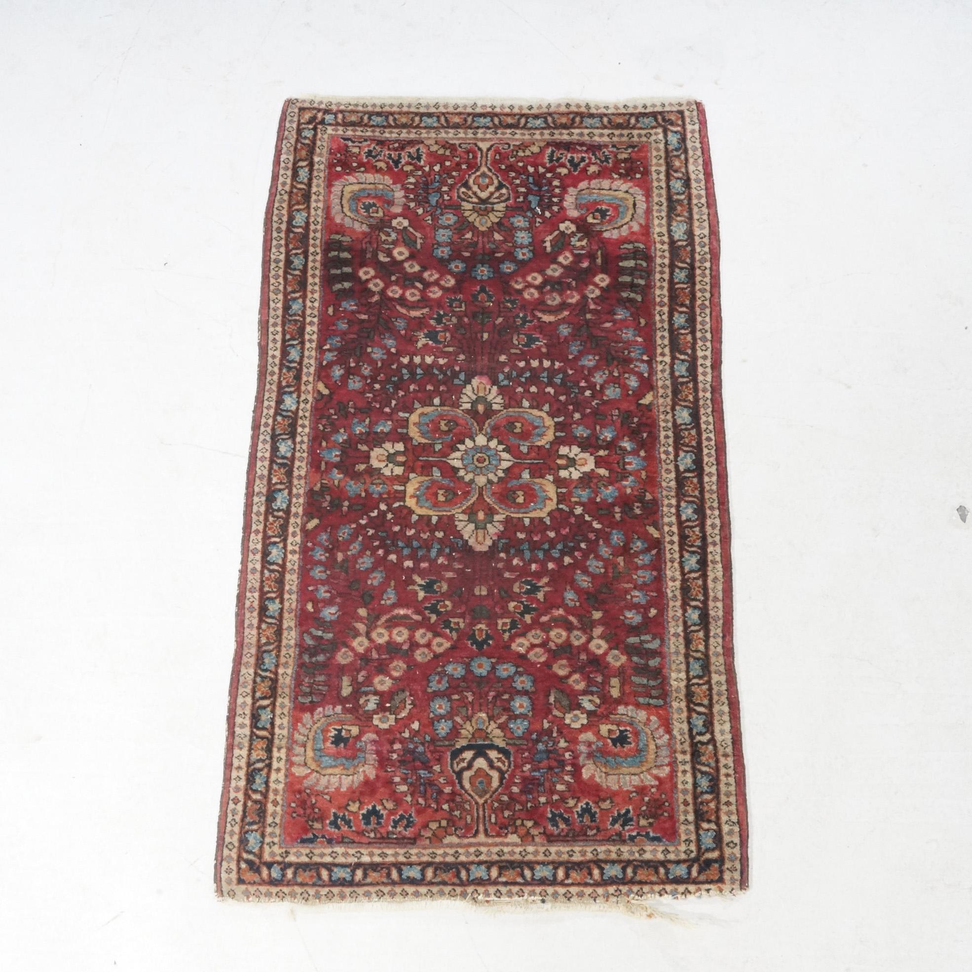 An antique Sarouk oriental rug offers wool construction with central medallion and foliate design on red ground, circa 1930.

Measures - 24.5