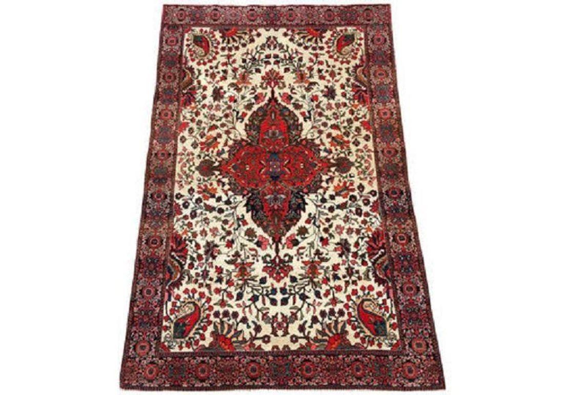 A stunning antique Sarouk rug, handwoven circa 1910 with a terracotta red medallion on an ivory field surrounded by a narrow blue border. Lovely secondary colours including blues, pinks, reds and greens and fabulous wool quality.
Size: 1.98m x 1.27m