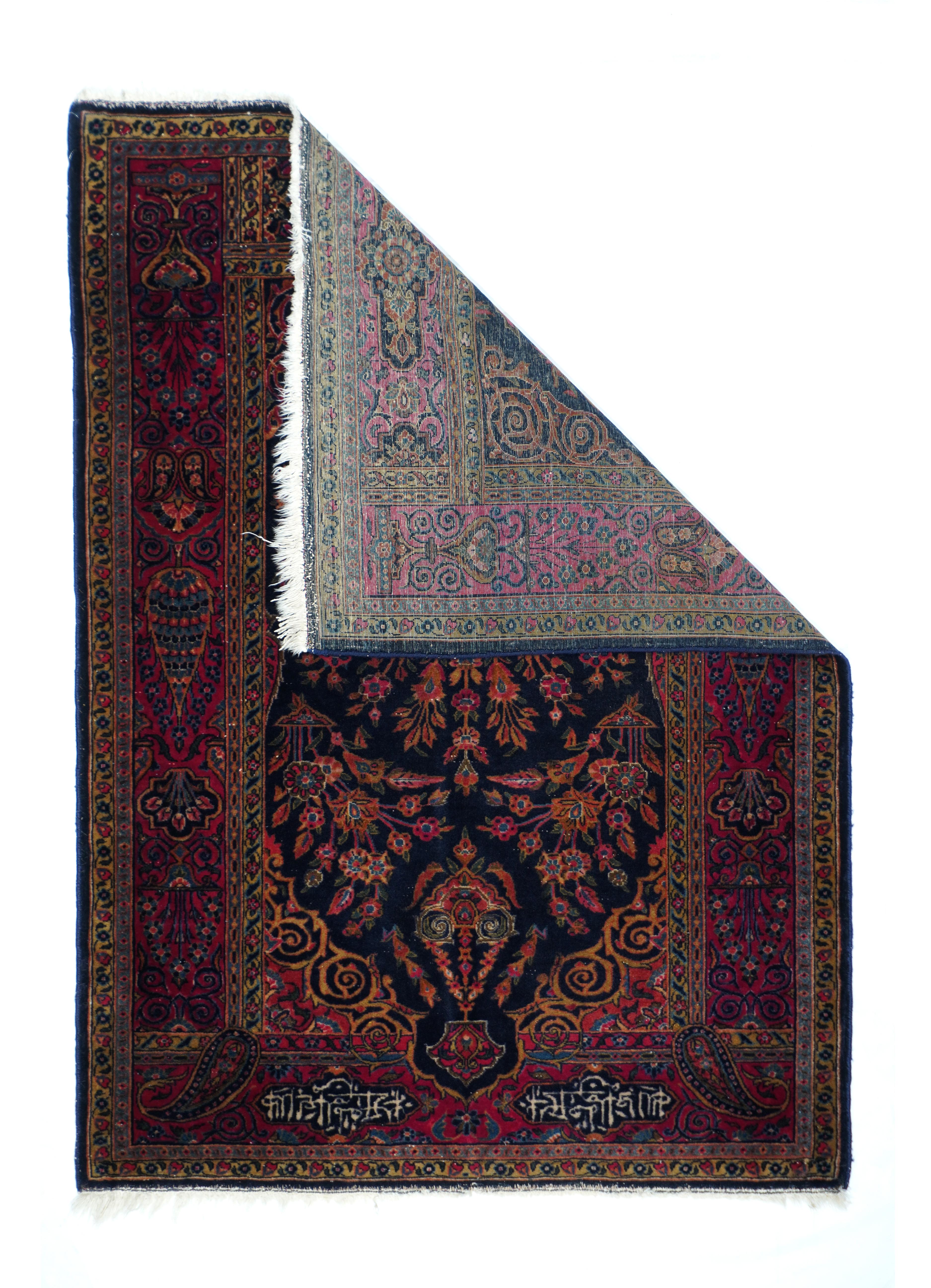 Antique Manchester Kashan Rug 3'6'' x 4'10''. The niche shaped navy field is based with a vase spreading luxuriant multi-flower stems, with a floriated lamp at the vertex. More flowers spring from two side dishes. Gold volute spandrels. Ruby red