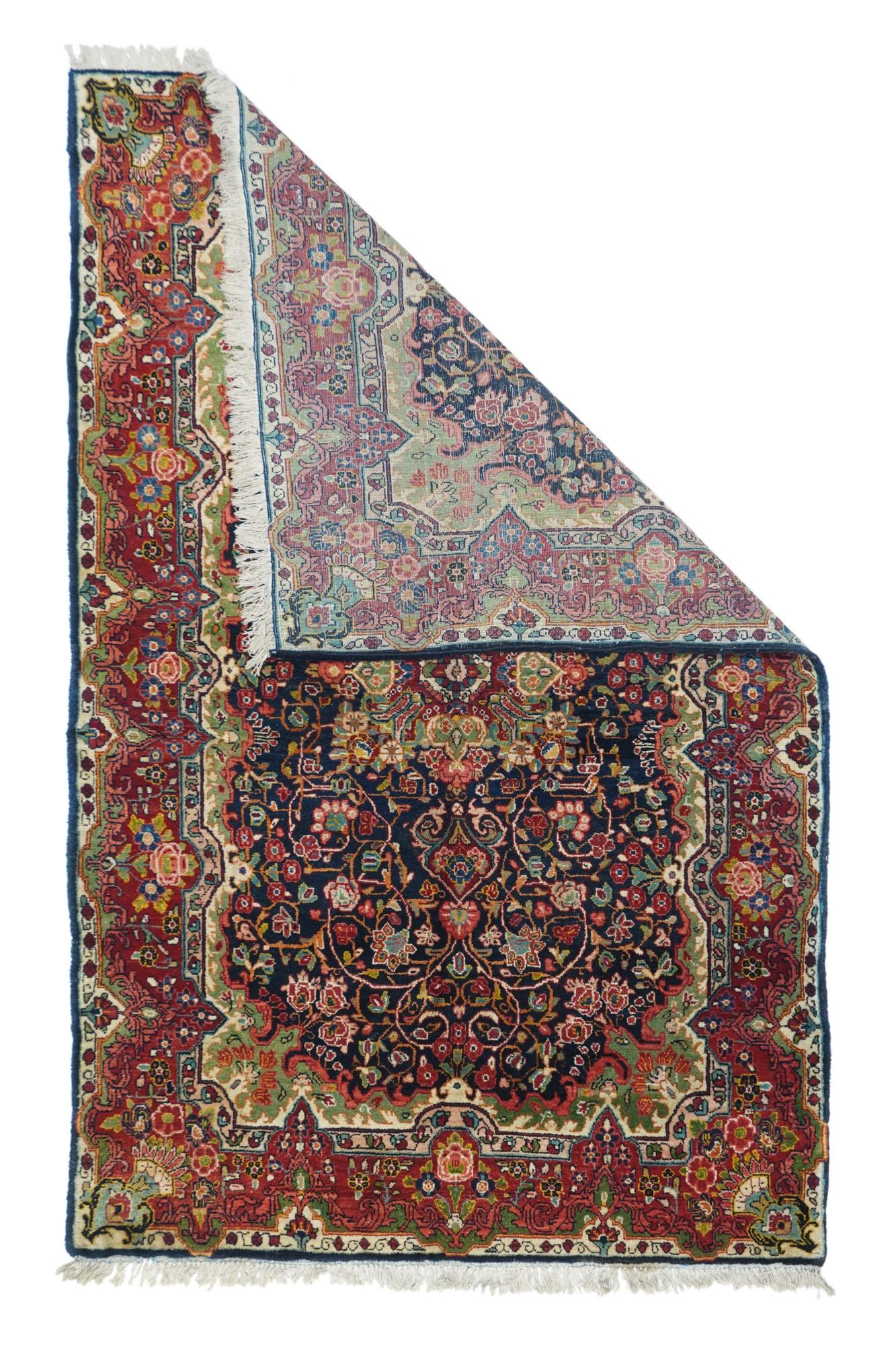 Antique Sarouk Rug 4'5'' x 7'2''. This vintage, west Persian rustic scatter features a notched and flaming rectangular navy sub-field with a four palmette octogrammoidal medallion centred on a wine red rosette. Staccato ecru vinery. Ecru field is