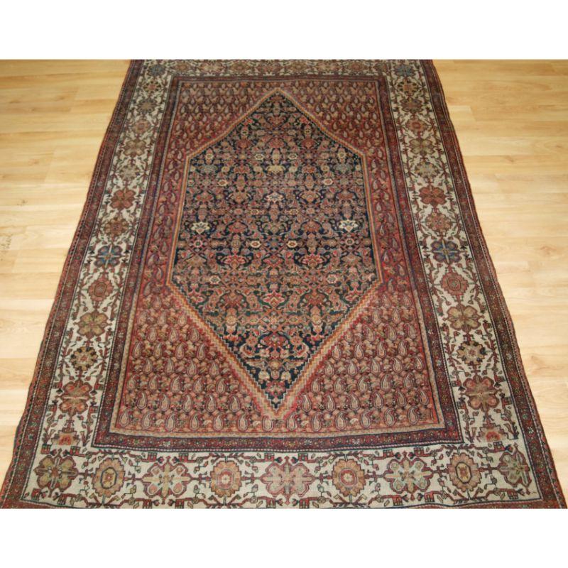 Antique Sarouk rug with central medallion.

A good rug of classic Sarouk design, with fine detailed drawing. The rug has a very soft colour palette and the ivory border gives it a very light feel.

Good condition with even wear and medium/low