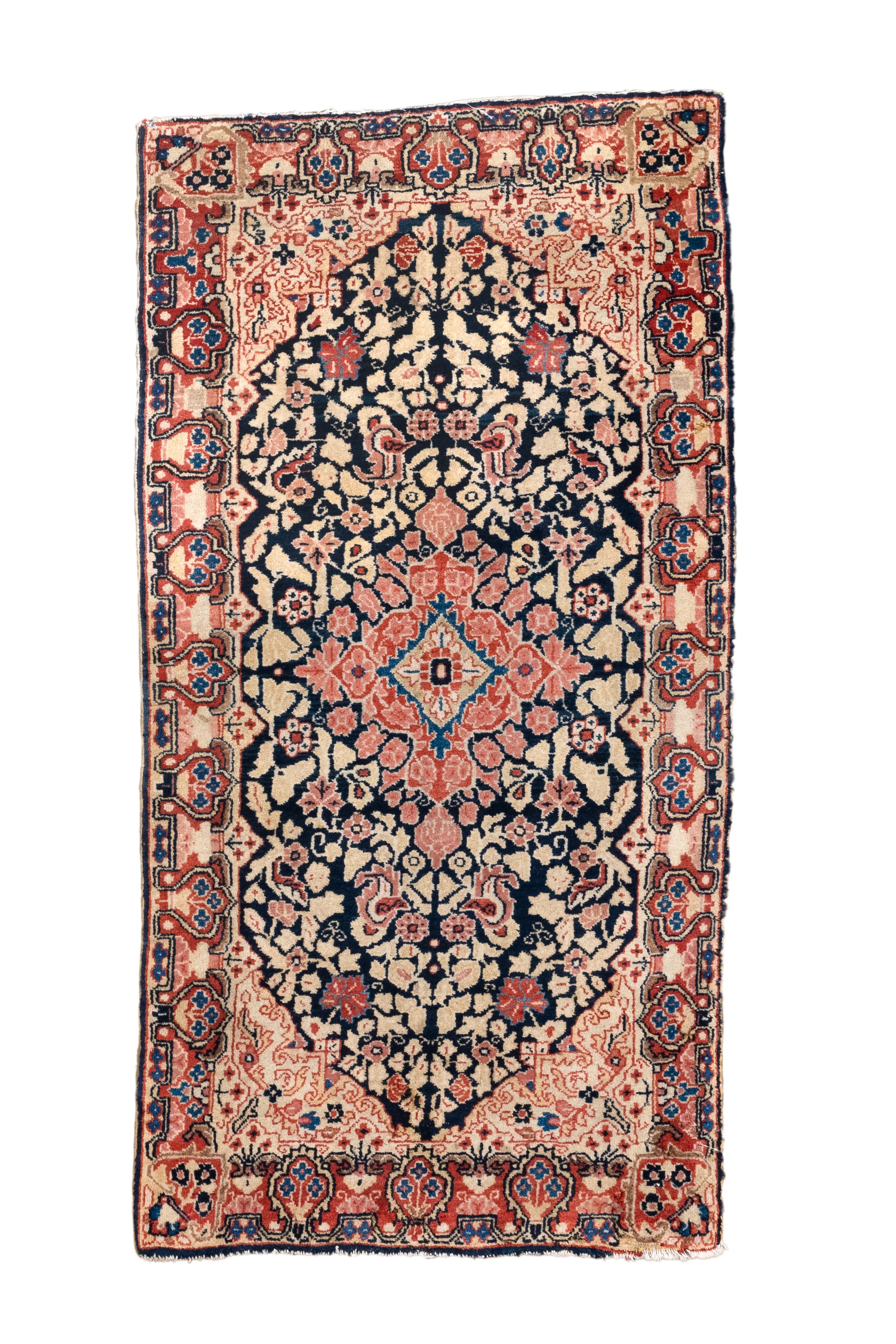 The end-pointed and pinched navy field shows a reticulated rose diamond medallion supportedby a close scatter fill of stylized flowers, set within ecru corners.  Red border with red flowers-in-vase modules. Finely woven, good village work. A whole