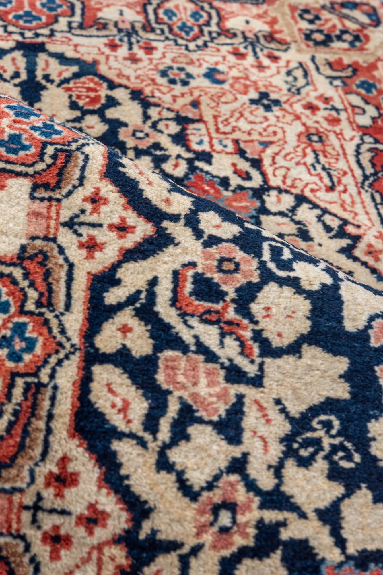 Wool Antique Sarouk with Navy Field and Floral Design For Sale