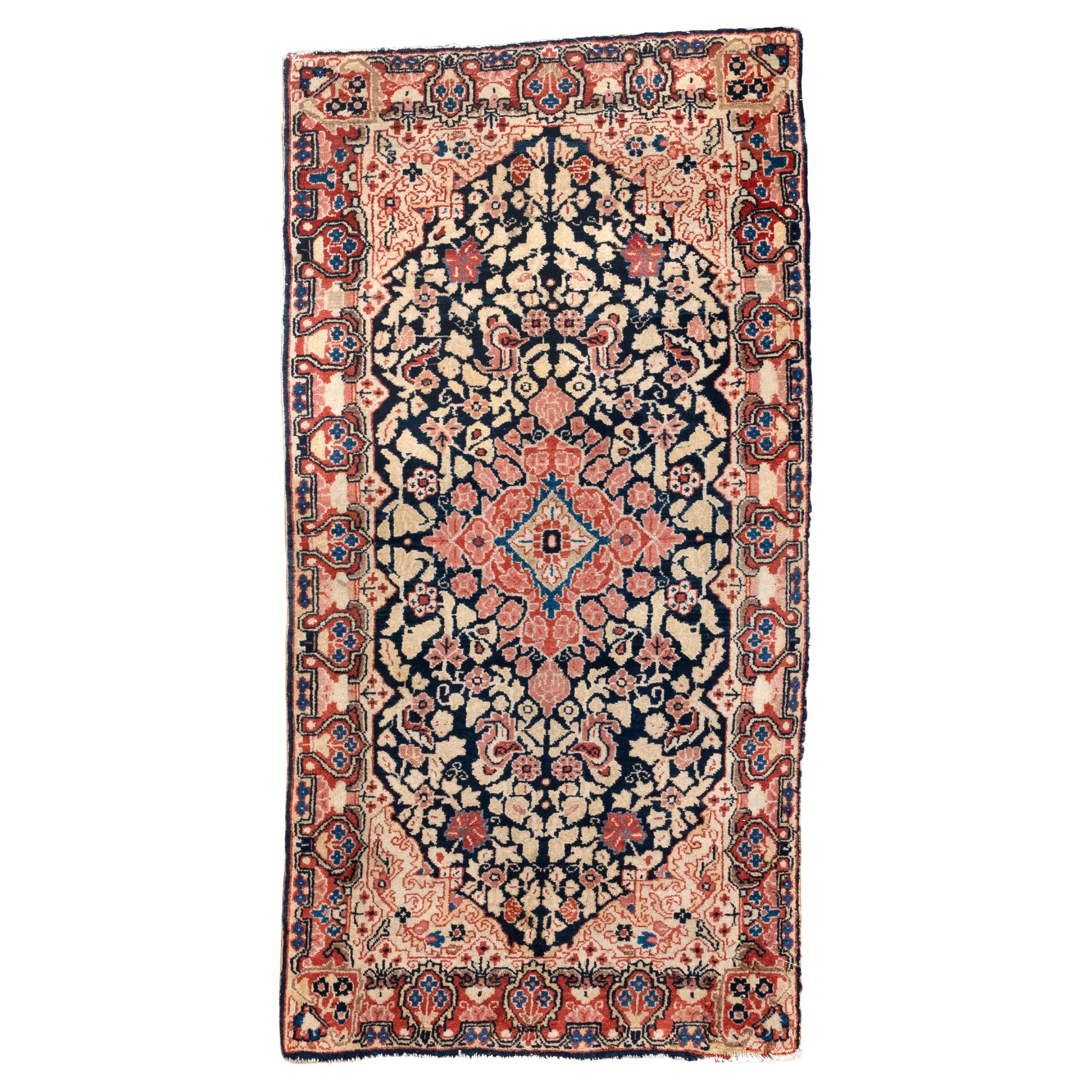Sarouk ancien avec motifs floraux et champ bleu marine