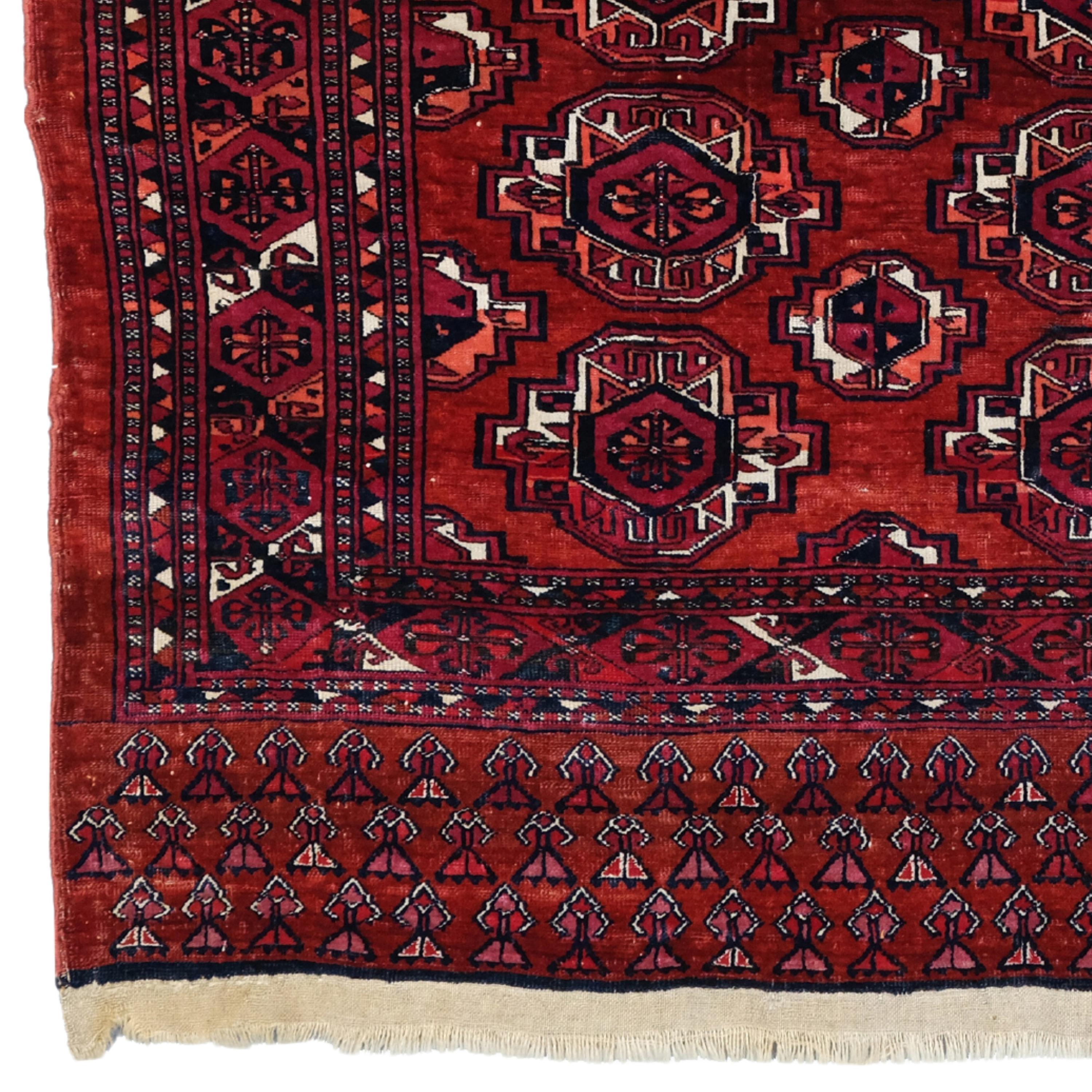 Saryk Chuval  Central Asia Rug

A classic Saryk chuval presenting twenty primary guls, chemche secondary designs and kochanak hook forms in the main border. The wide elem and a narrow stripe at the upper end are decorated with small plants. This