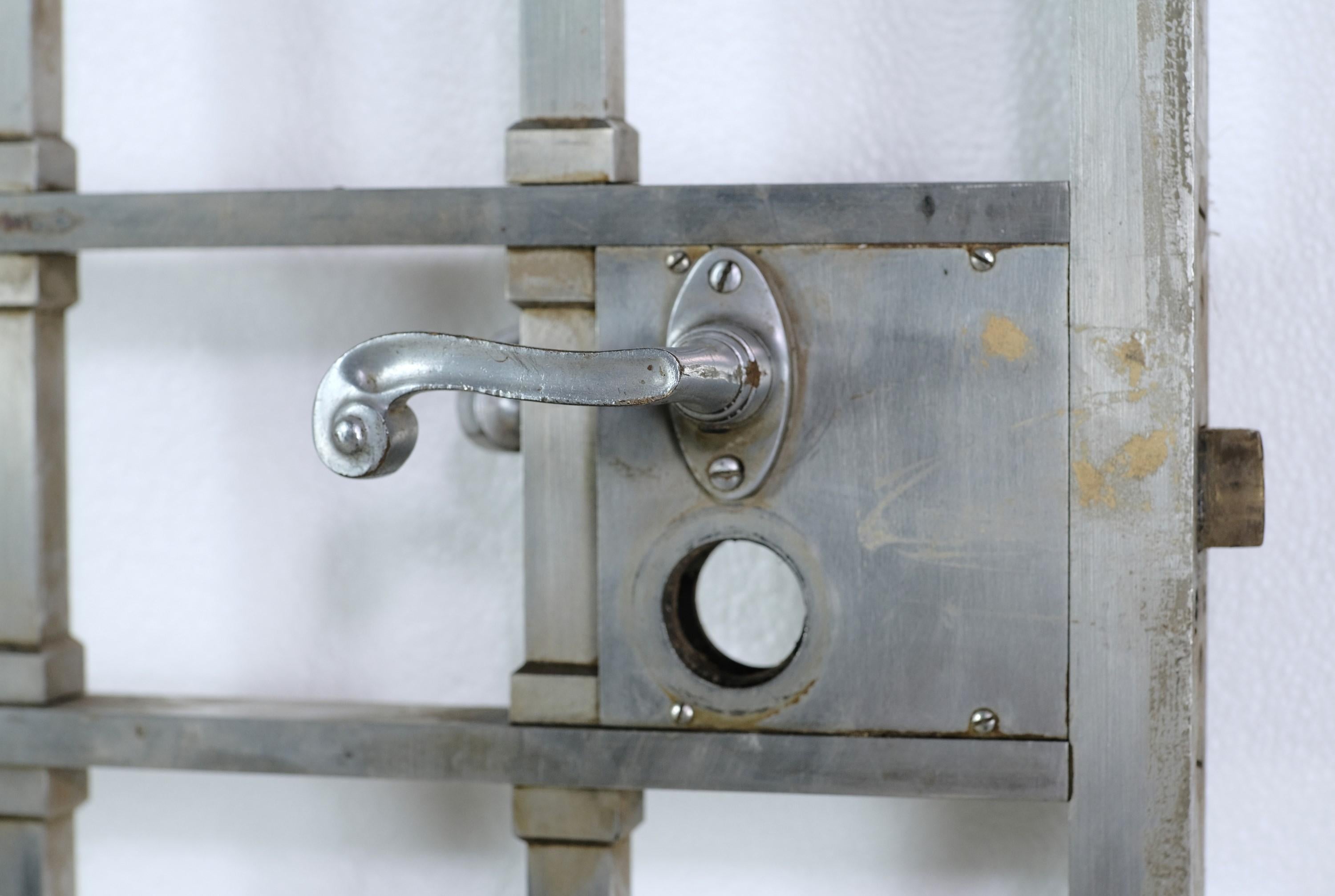 Solid brass entry gate with satin nickel plating and the original lever handles. This was reclaimed from an early 20th century New York City bank or other commercial building. The lever mechanism is working and is ready to receive a newly keyed