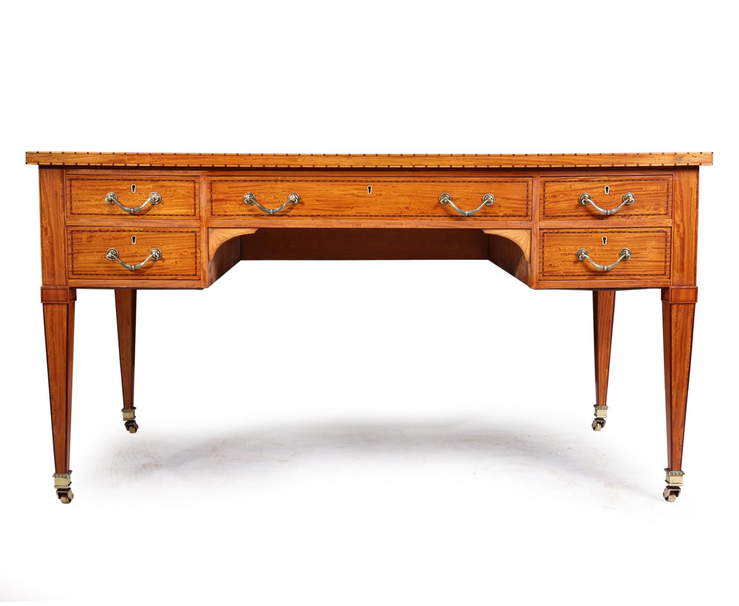 Antique satinwood desk, circa 1890

A antique satinwood desk produced in Paris in circa 1890, it has five drawer with swan neck handles and English locks, it has extra space slides to either side, original leather top, tulipwood and ebony inlay