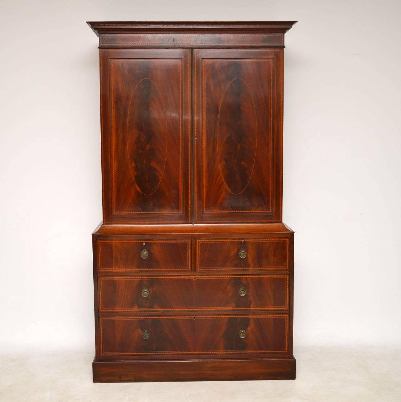 This antique linen press is extremely fine quality and in good original condition. Dating from the 1890s period, it has many fine features. The satinwood inlays are all over the front, which is also flame mahogany. There's a brass beading between