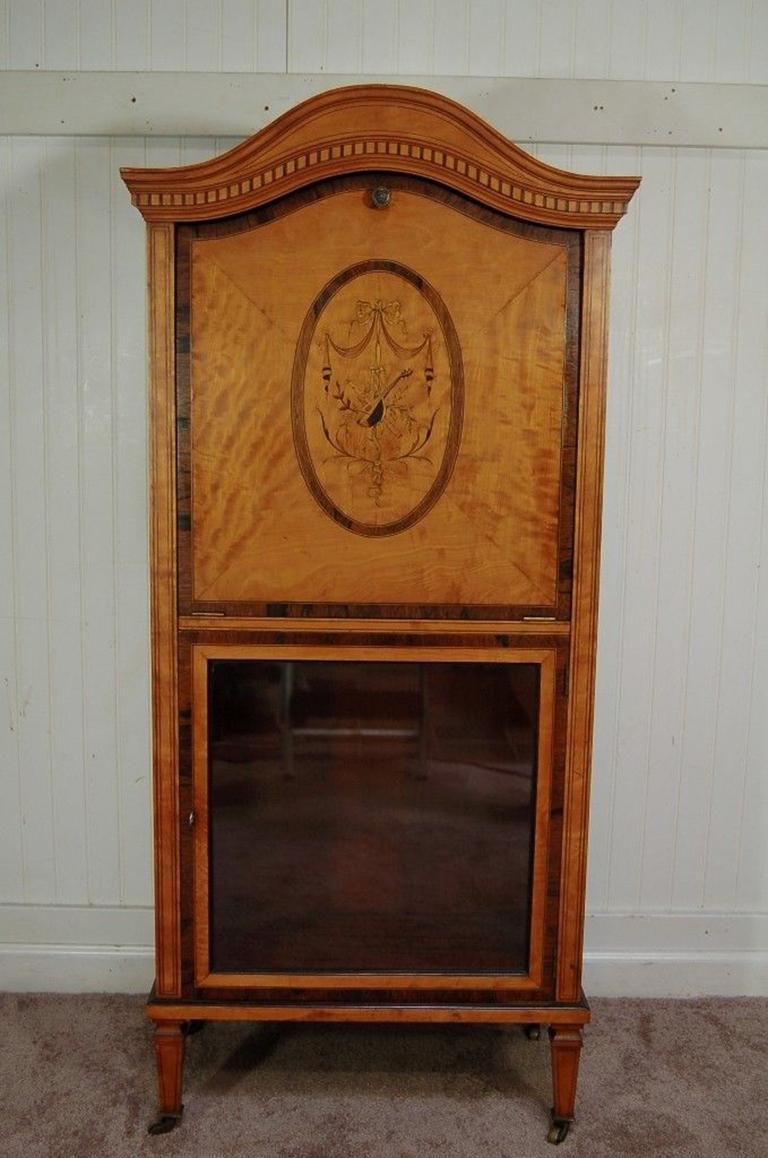 Fantastic antique 19th century satinwood hand inlaid French sheet music cabinet in the Adams style. Item features beautiful and finely inlaid detailing, dovetailed fall front door, rolling casters, dome top, remarkable French form, could even be