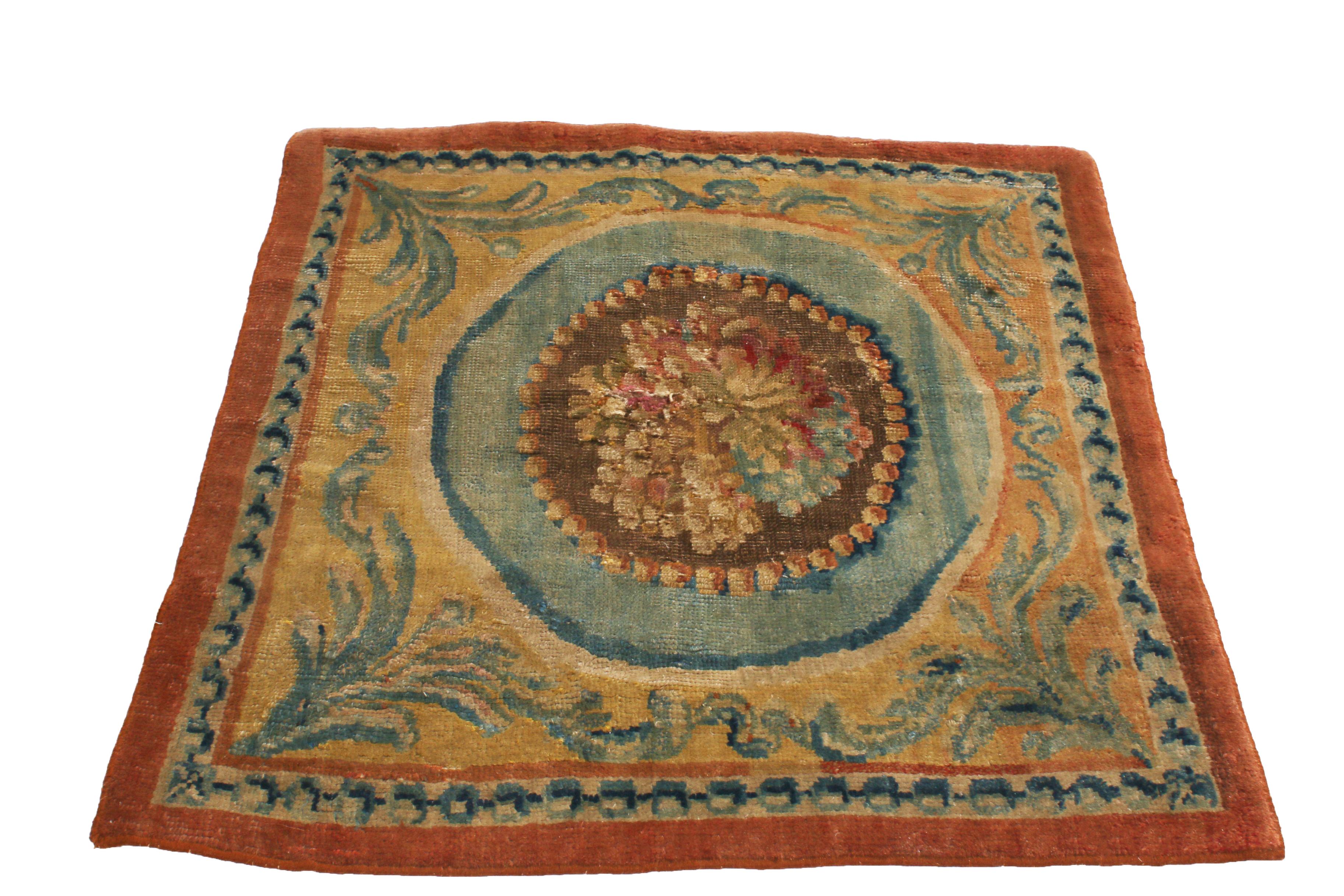 Originating from France in 1910, this antique Savonniere rug was hand knotted with wool pile hailing from one of the most widely regarded European rug manufacturers for multiple centuries, often paralleling the most treasured Aubusson pieces of each
