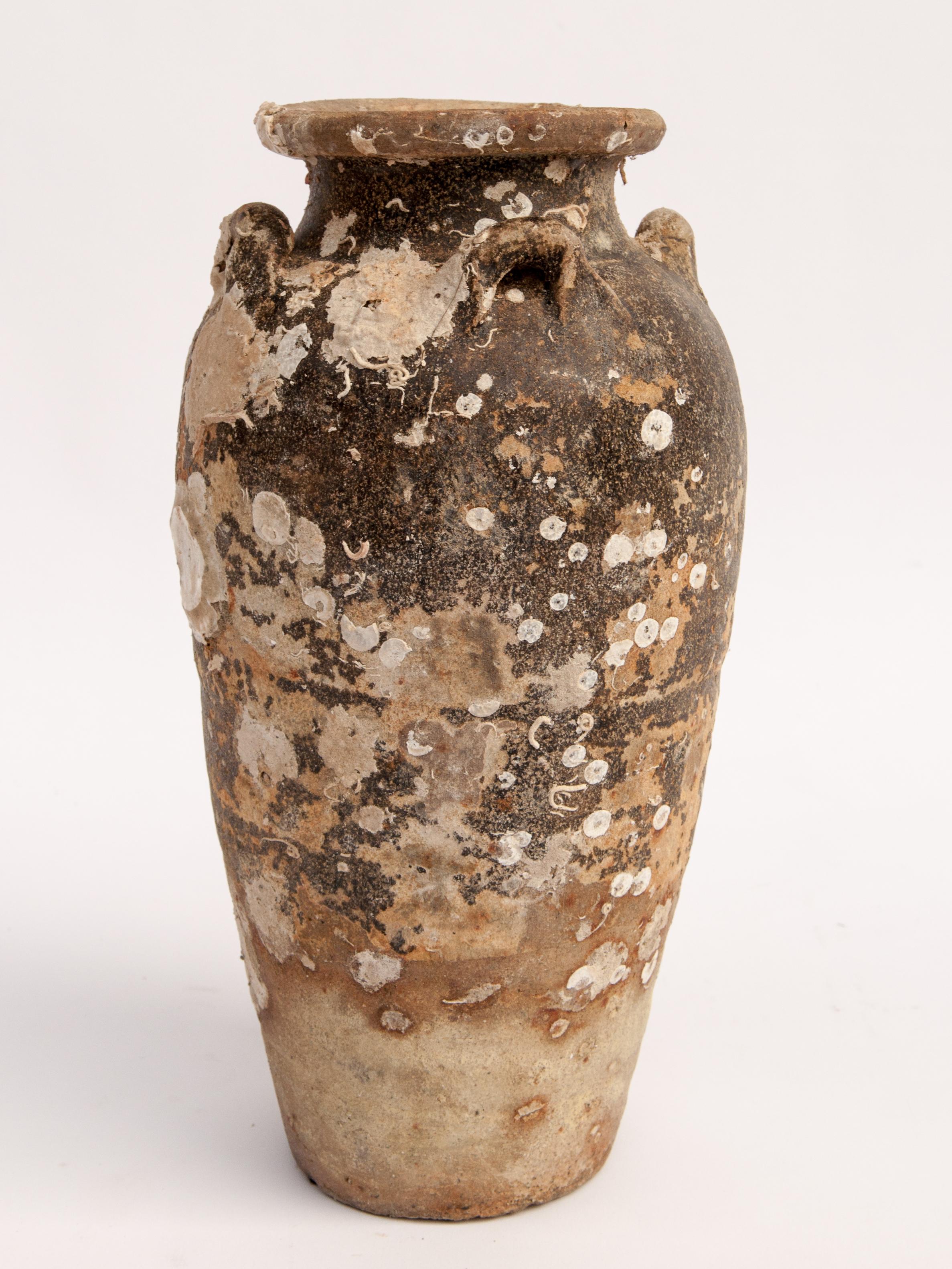 Antique Sawankhalok Jar with Encrustations. Sawankhalok, Thailand, 15th century.
This jar originates from the kilns of central Thailand centered around the area of Si Sachanalai dating to the Sukhothai period. Sawankhalok ceramics were widely